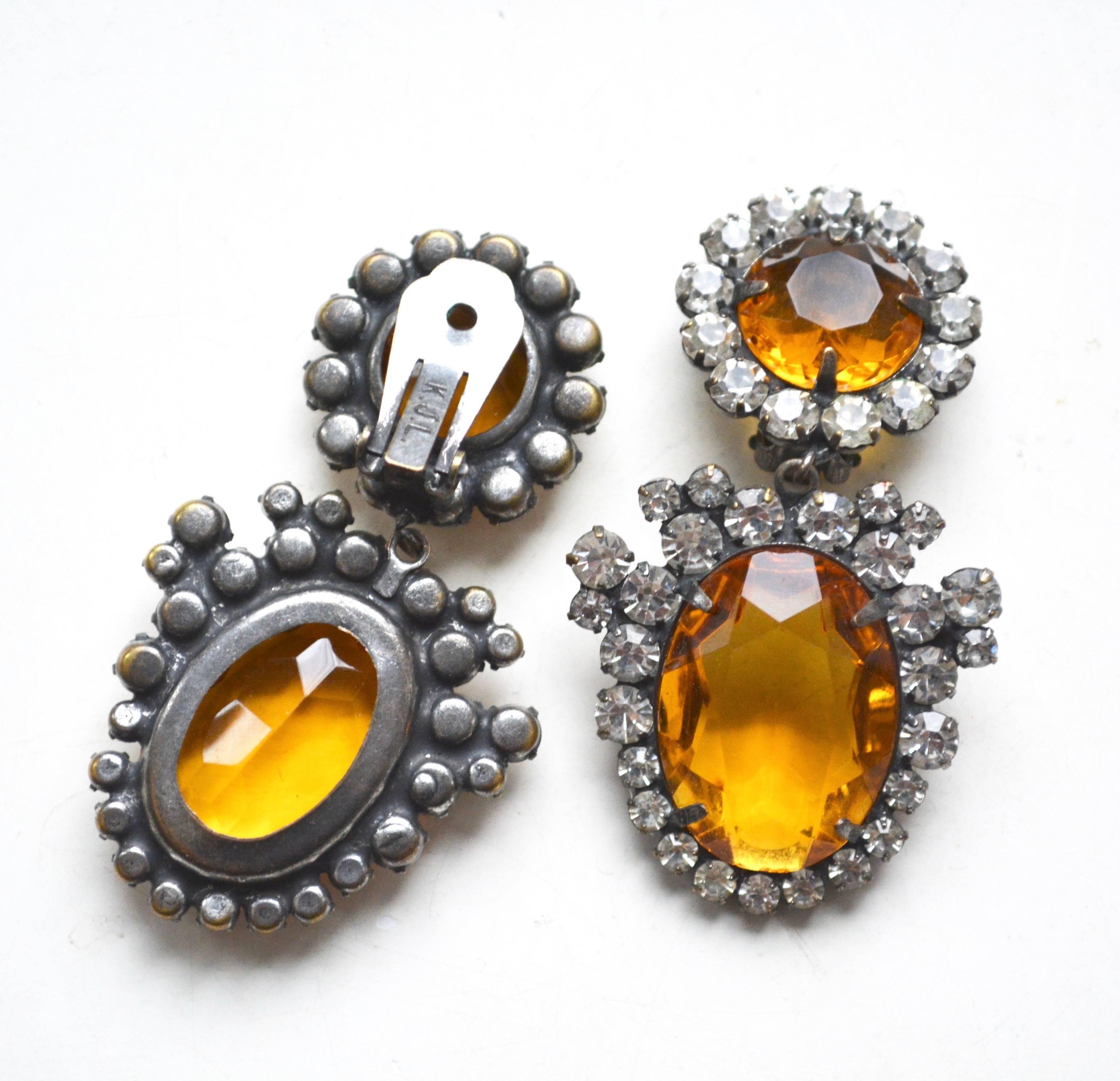 Signed Kenneth Jay Lane earrings in a lovely amber toned glass with rhinestone accents.  2.5
