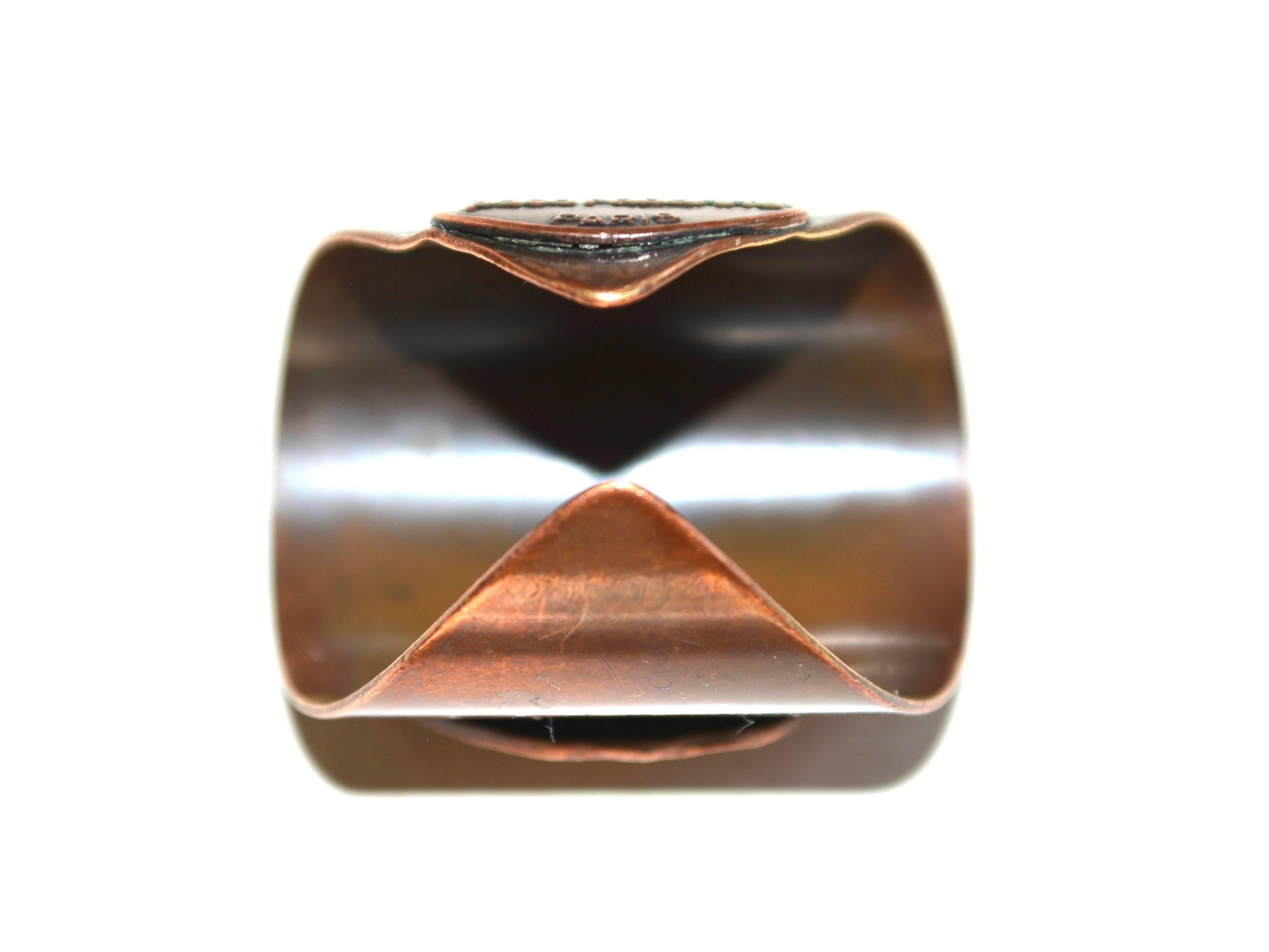 Abstract mod 1960s signed copper adjustable ring. The face is about 1 1/8" long and is sized at about a 7 now, but could be changed slightly. Slight wear to the back bend. 