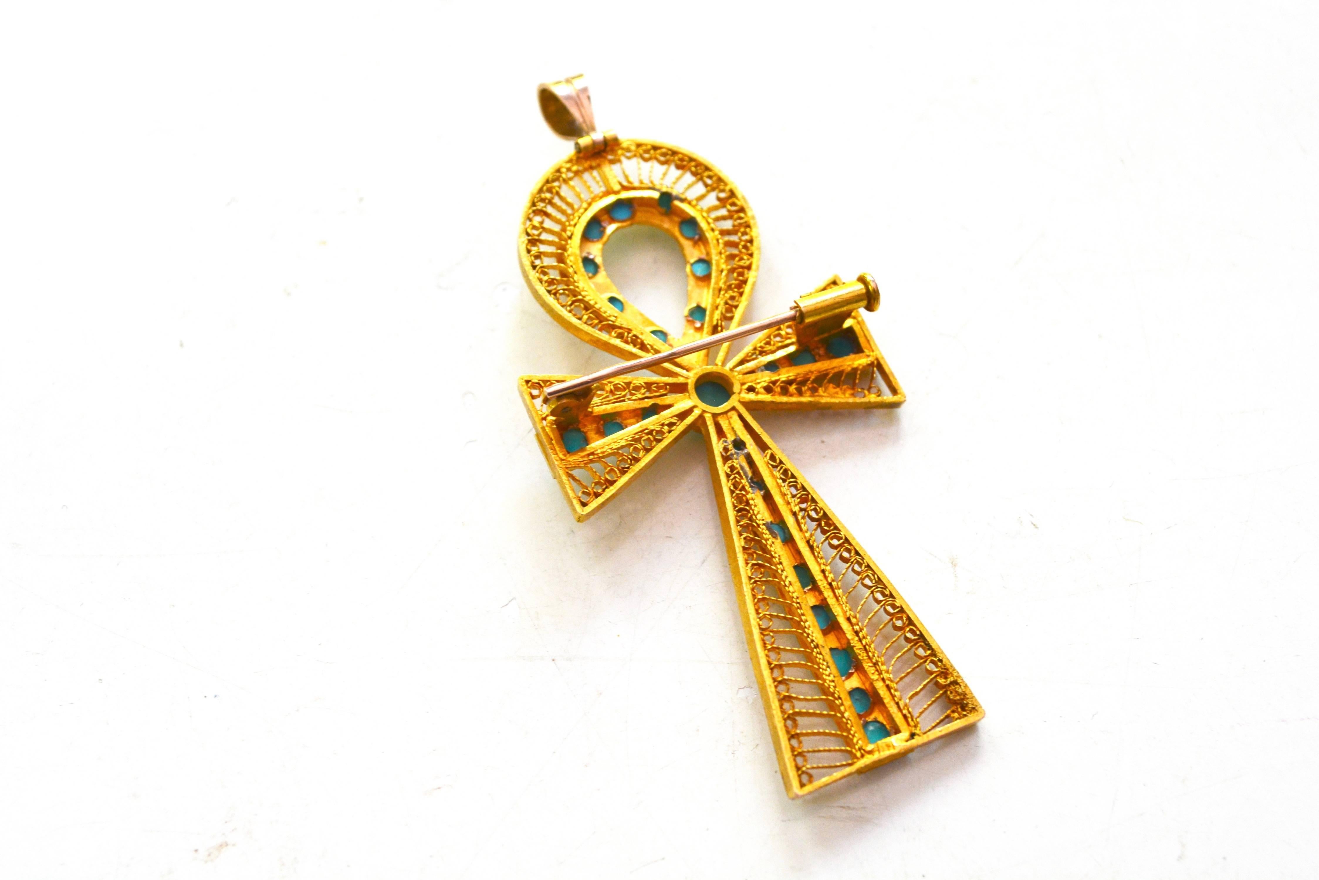 18K Early 1900s-1920s turquoise ankh brooch and pendant. Unsigned. Trumpet clasp with a retractible hook for the pendant. Nice larger size which can be worn alone or added to other charms. 2.5" long x about 1.25" wide. 
