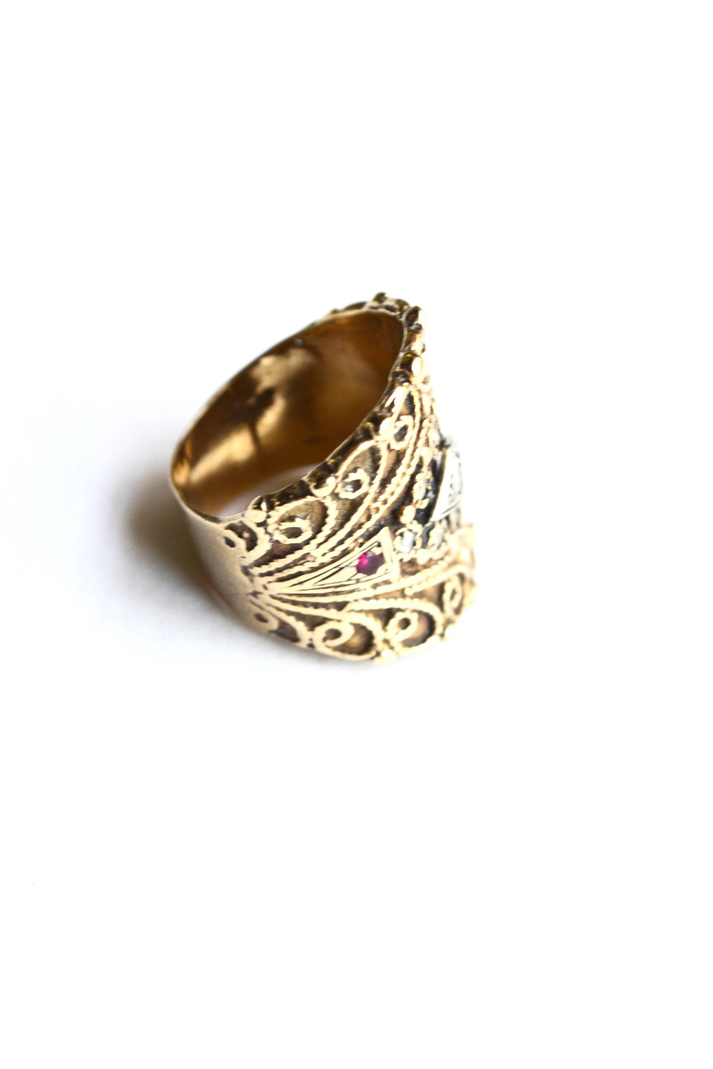 Ruby and diamond 14k "cigar band" style ring. Size 6, unsigned. Band width varies at a bit over 1". Condition is good with some fine wear.  Unique design. 