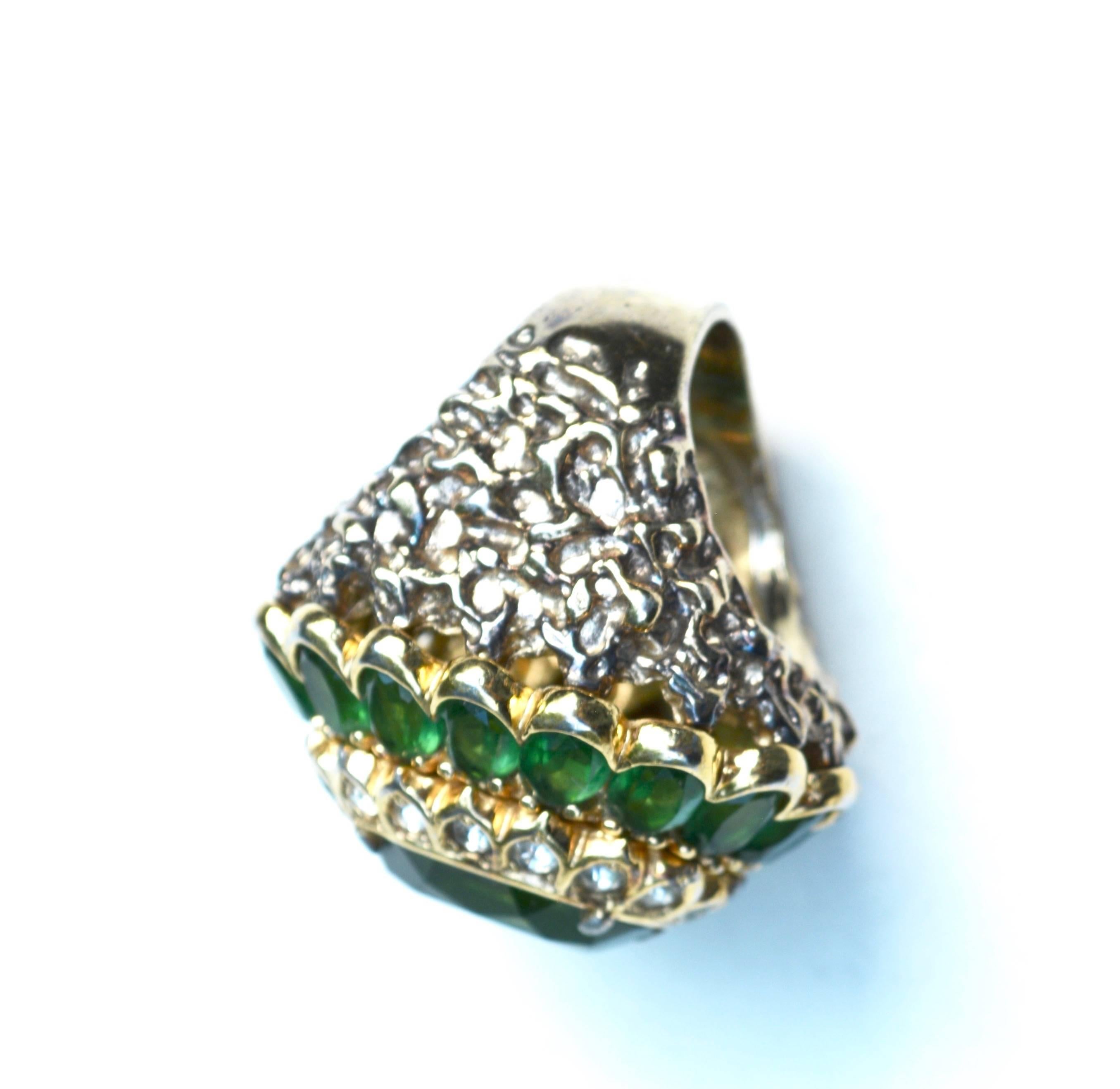 Oversized green glass signed Panetta 1960s-70s cocktail ring. Good overall with a bit of wear to the stone in the form of a graze- thin scratch, see images. Great vibrant green. 1.75″ long by 1.5″ wide face. Size 7 ring.