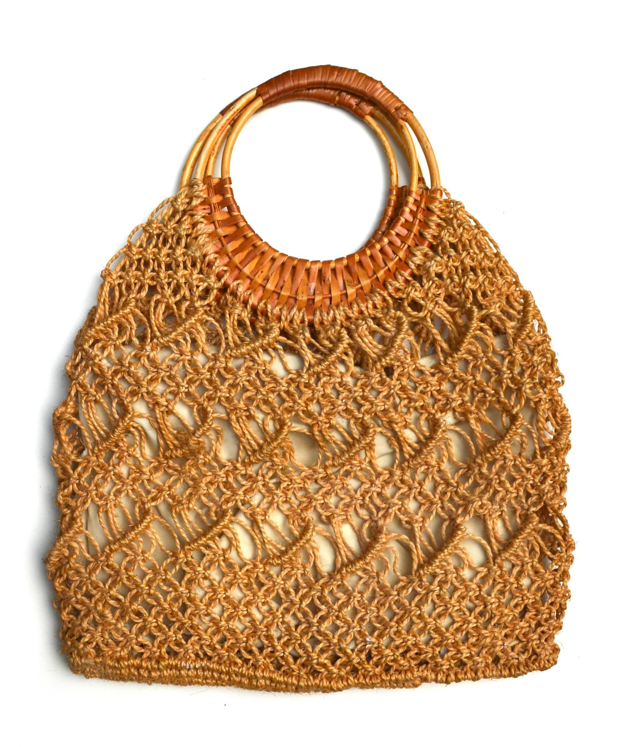 Oversized Macrame bag with cotton lined interior and orange metal zipper. Large wristlet style with an opening of 6