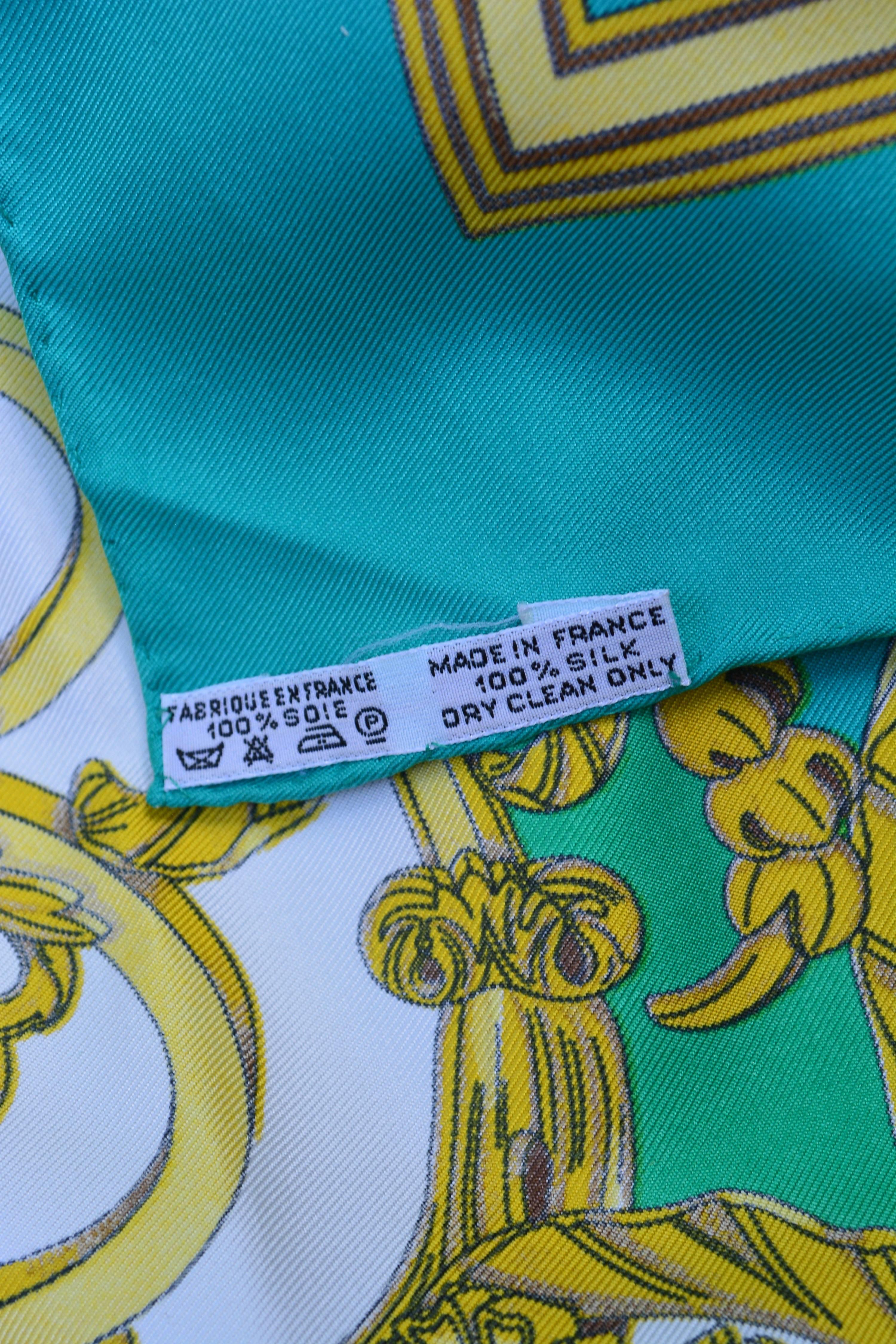Hermes Paris Les Tuileries turquoise silk scarf with care tag. Hallmarked J Metz with another Hermes hallmark across form it. Great color and condition.  35