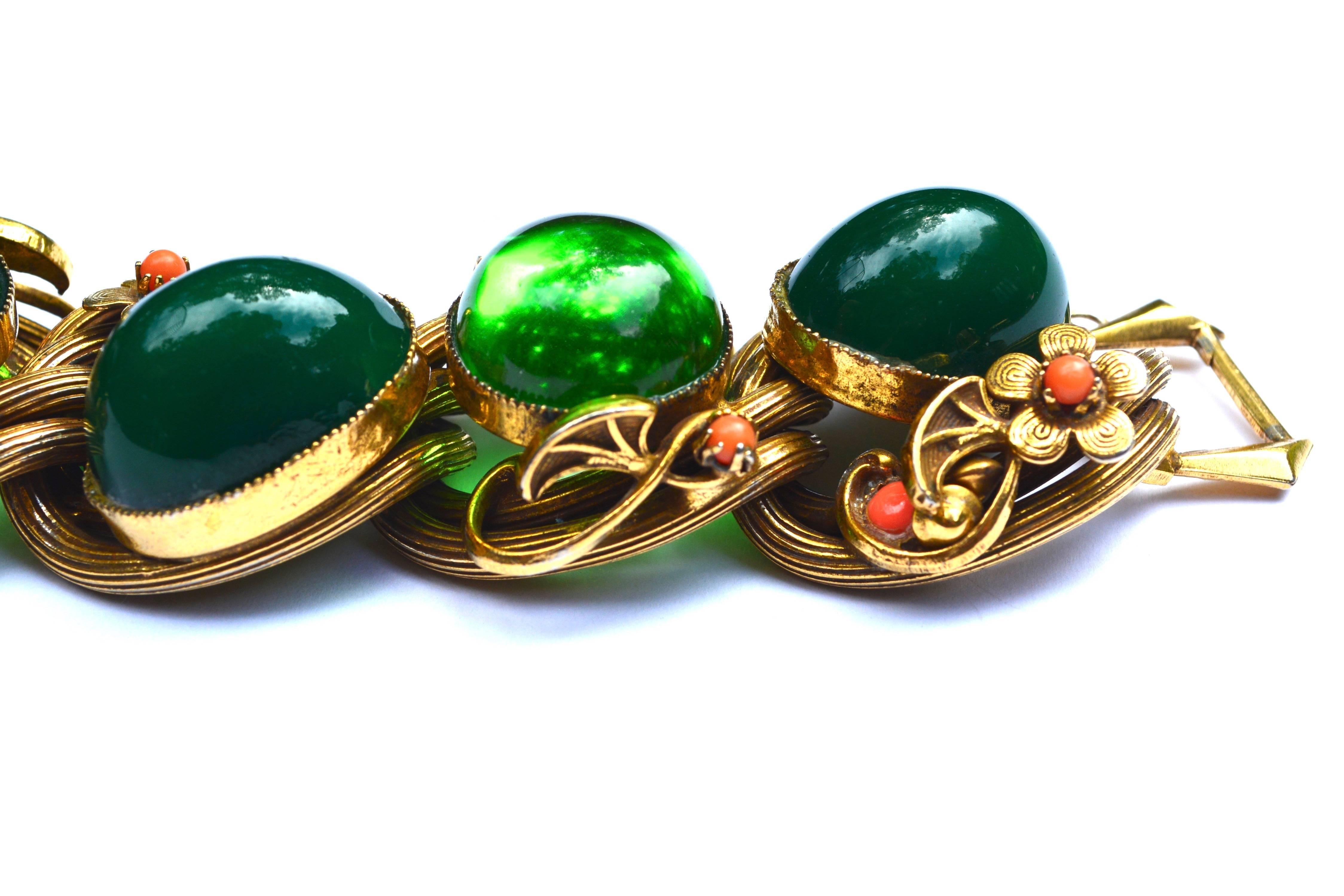 50s oversized two toned glass bracelet. Construction appears to be very similar to Selro, but it is unsigned.  The cabochons appear to be frosted darker green glass with faceted boarders and lighter apple sauce style green glass pieces. The chunky