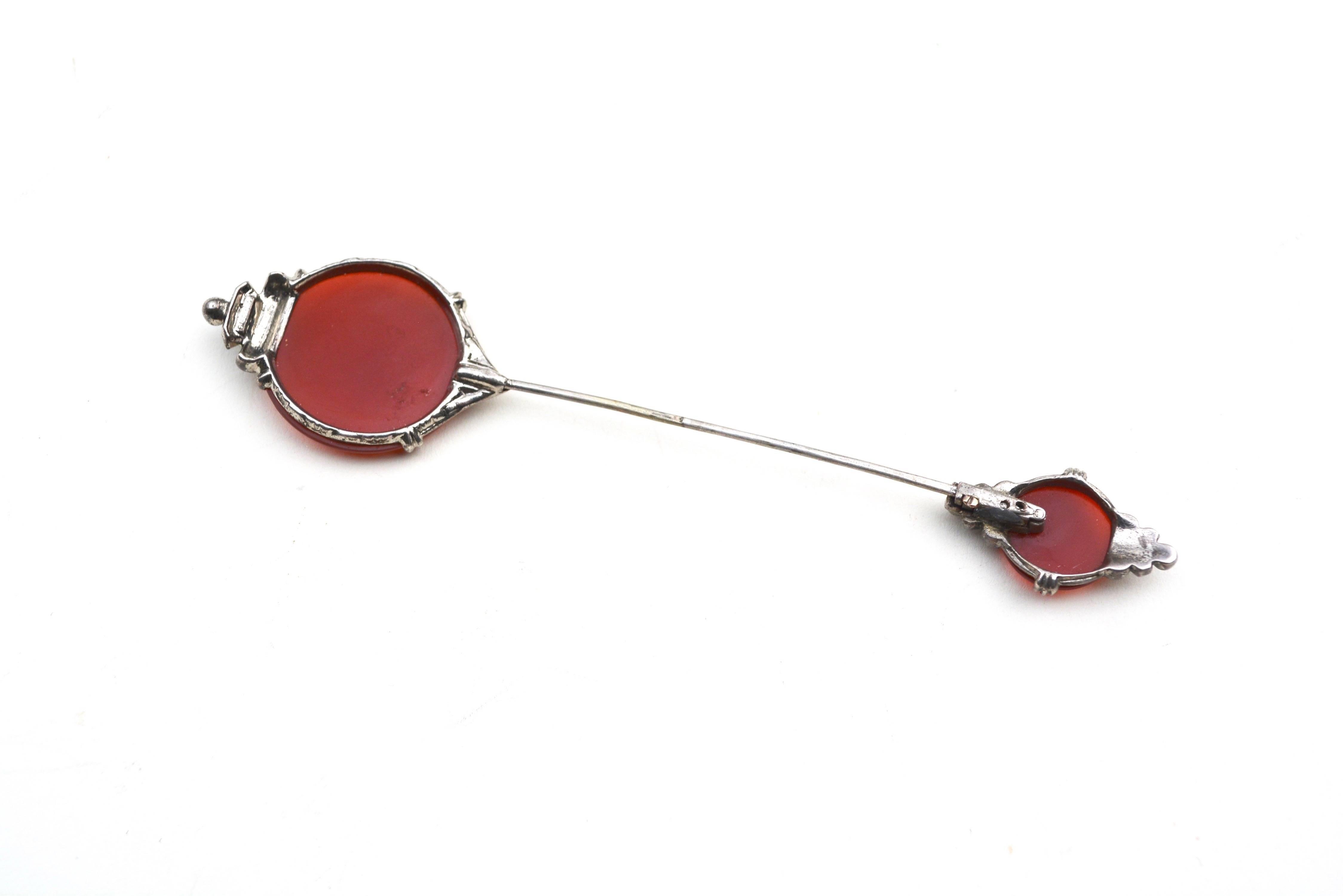 Hat pin made of sterling and marcasite details. Carnelian stones. Lovely example. Closes, but closure has some wear overall, yet stays closed. Stamped sterling. 4.5