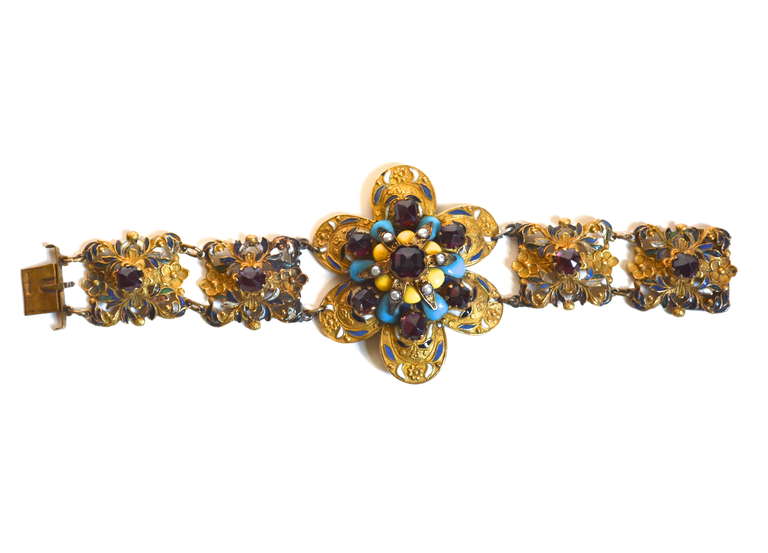 Large floral signed Hungarian cuff with enamel, glass, and gilt metal details. Floral top section, 3.5