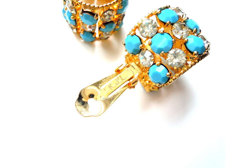 Wide turquoise glass stone and clear rhinestone Kenneth Jay Lane hoop earrings. Signed with the collectible 1960s signature 