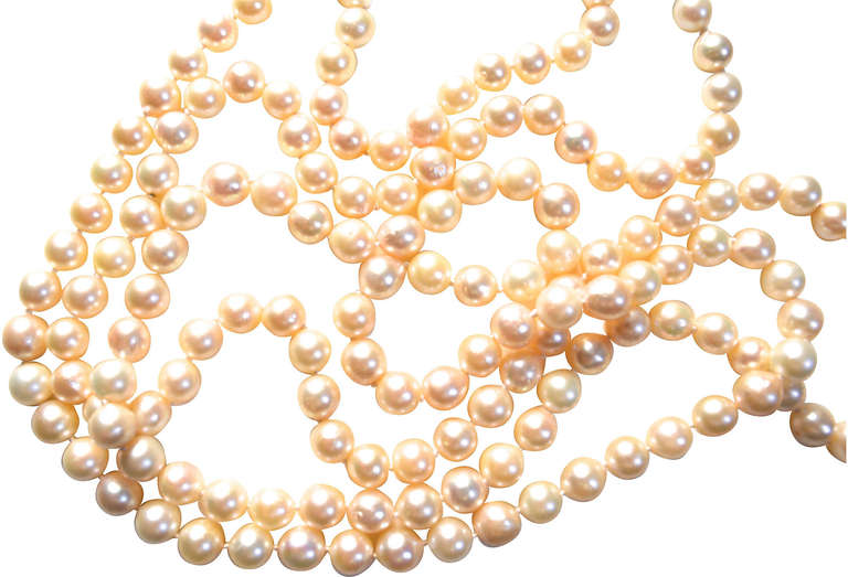 Cultured 1940s Japanese Akoya pearls restrung as a 64″ pearl necklace with the original 14K-and-pearl clasp which allows one to wrap it multiple times around the neck or wrist depending on your size. Old Akoya pearls that have been graded as 8.5-9mm