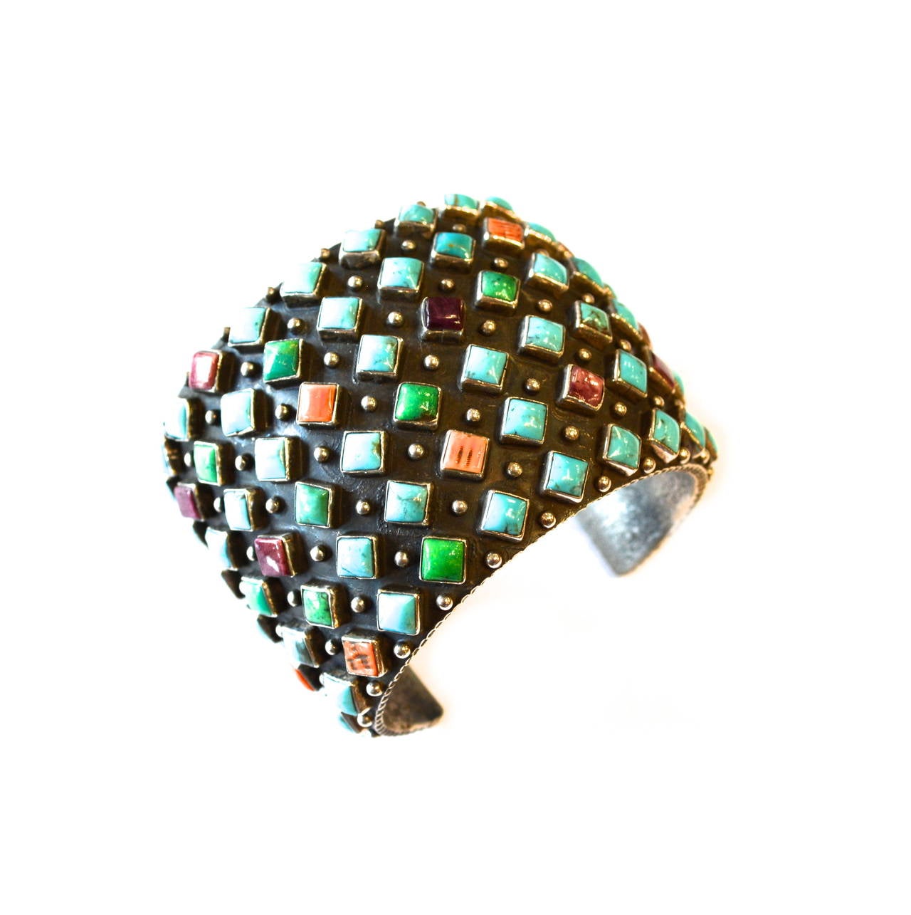 Gorgeous multi colored sterling rounded stud and geometric turquoise gemstone cuff. Signed R sterling.  Features blue and green turquoise stones, coral and amethyst in a diamond design. Circa 1970s-80s.  Appears to be sand cast in texture, per the