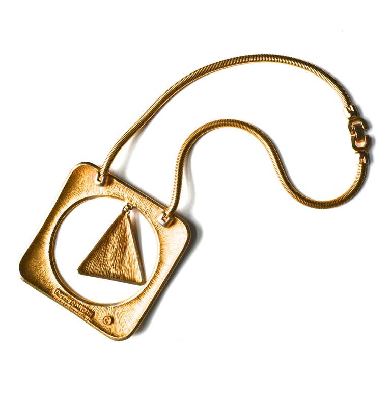 Mod Pierre Cardin signed geometric two toned necklace. The silver finish appears to be an enamel. The triangular pendant features a lapis blue glass stone.  Classic Cardin construction and design for the era. Pendant is 3.5