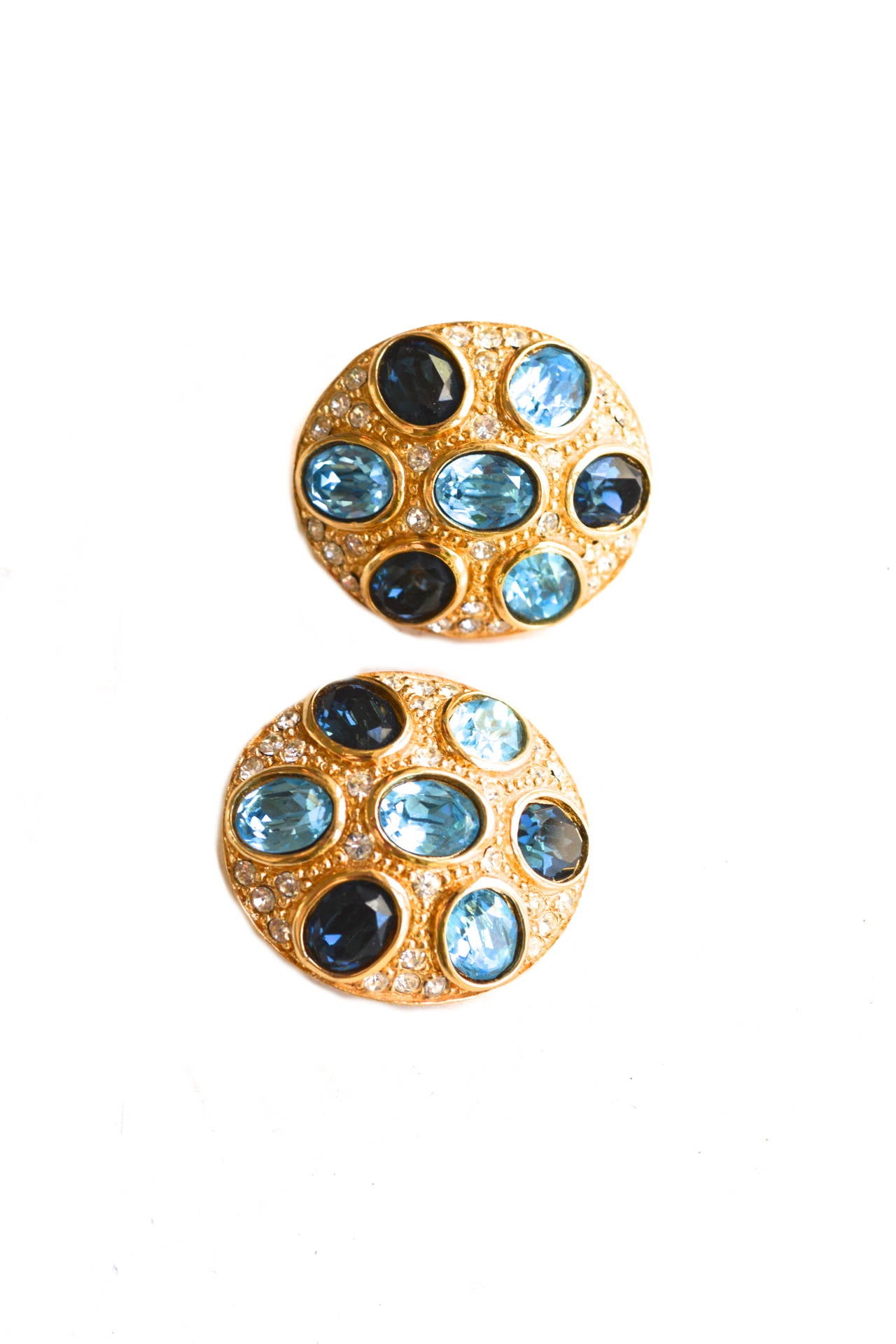 Pretty rhinestone and blue glass stone clip on earrings marked Christian Dior.  Golden metal finish and small paste stone details. Great chunky style without being too heavy.