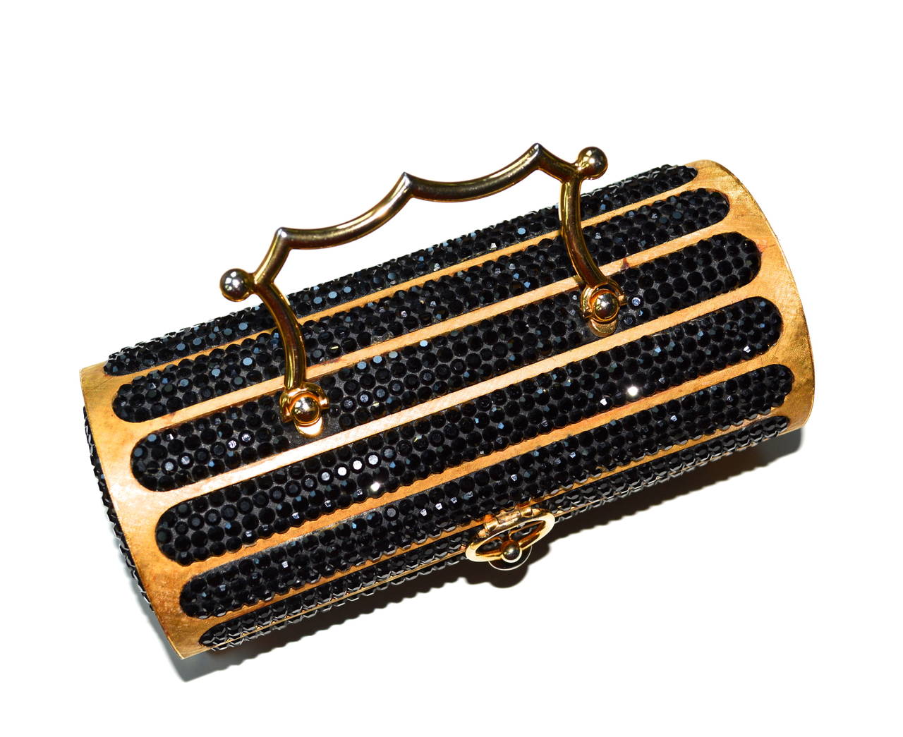 Rare early vintage Judith Leiber Florentined cylinder signed golden metal and black swarovski crystal handbag. Judith Leiber designed her first metal handbag in 1967 and started her line in 1963. This is a great piece, as it is earlier. The bag was