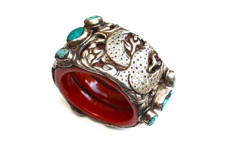 Vintage sterling bird and turquoise cuff set on what appears to be a resin in a deep burnt orange. Unsigned. Tibetan traditional design, collected from Tibet.