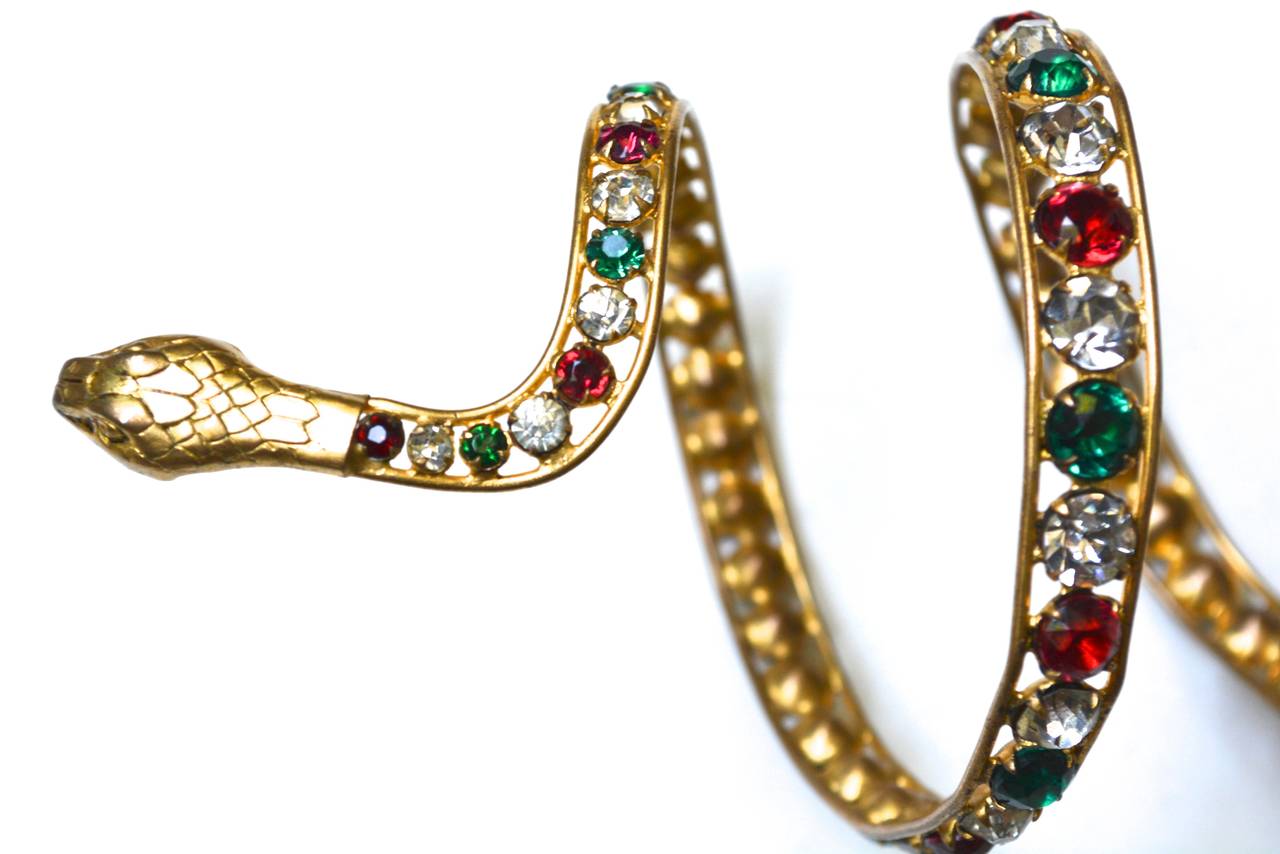 Deeply colored rhinestone and golden metal wrap snake bracelet from the height of French theater. Purchased in France. Reportedly used in the theater in Paris. From a collection of similar pieces which seem to validate the use of them in a