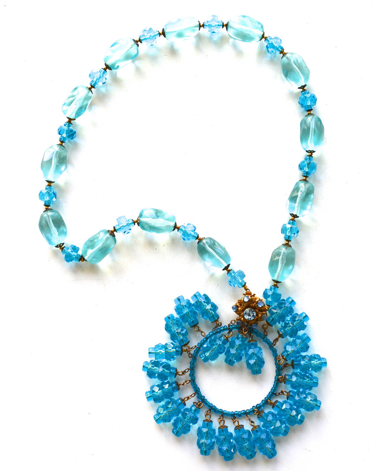 Wonderful faceted crystal and glass bead Miriam Haskell necklace. The vibrant turquoise blue and aquamarine nuances are quite gorgeous. The metal has a matte gilt finish. Excellent condition. The necklace measures about 18