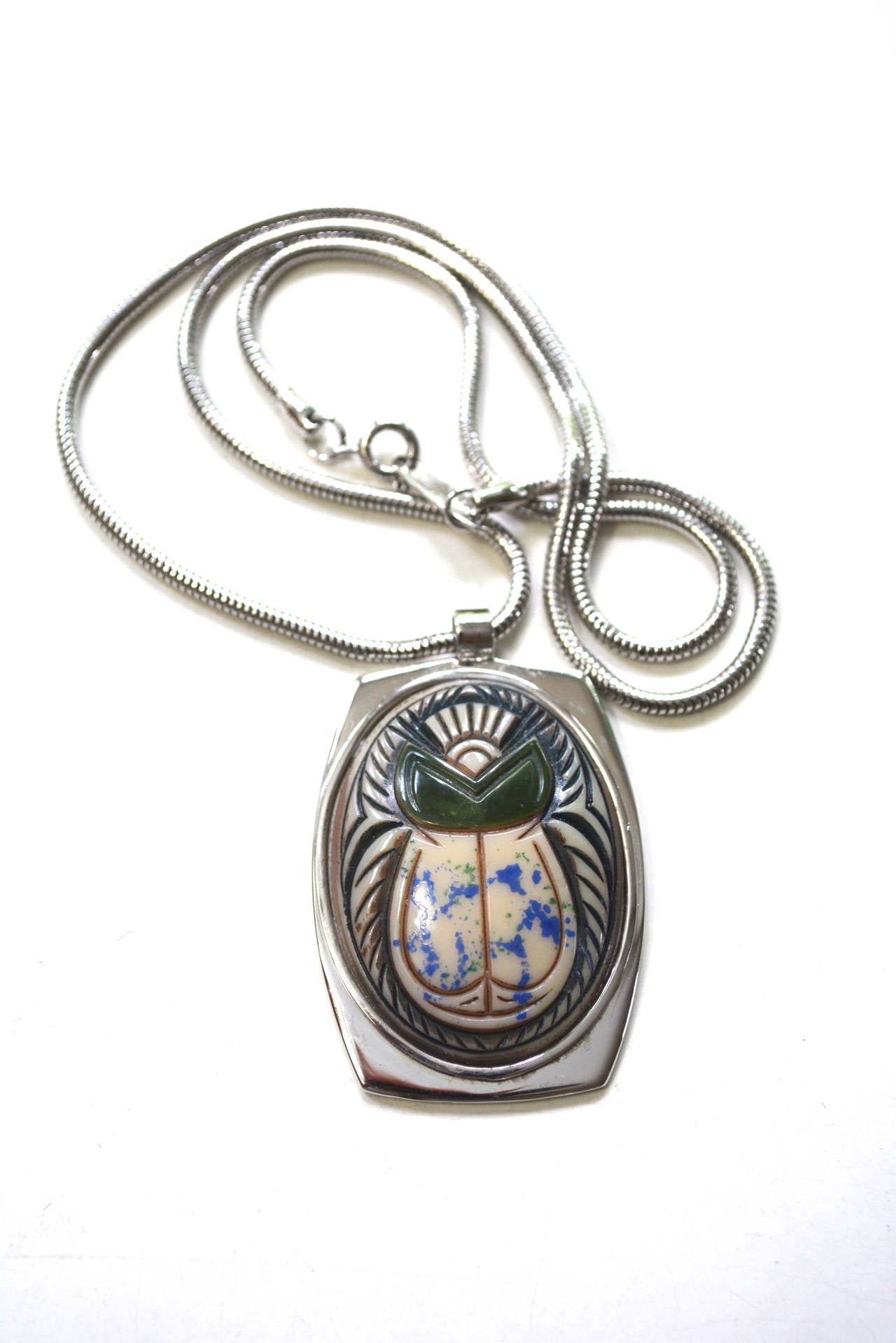 Signed Egyptian revival scarab necklace by Whiting and Davis. The piece has a snake style chain and an original dappled green and blue finish with shaded details.  The scarab pendant measures 2