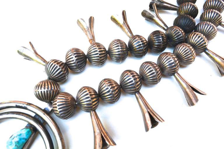 Spectacular 1940s old pawn squash blossom necklace straight from a southwestern source. Unmarked as are most pre 1960s pieces. The beads are substantial in appearance and weight with wonderful details, but it is a wearable weight. I had this piece
