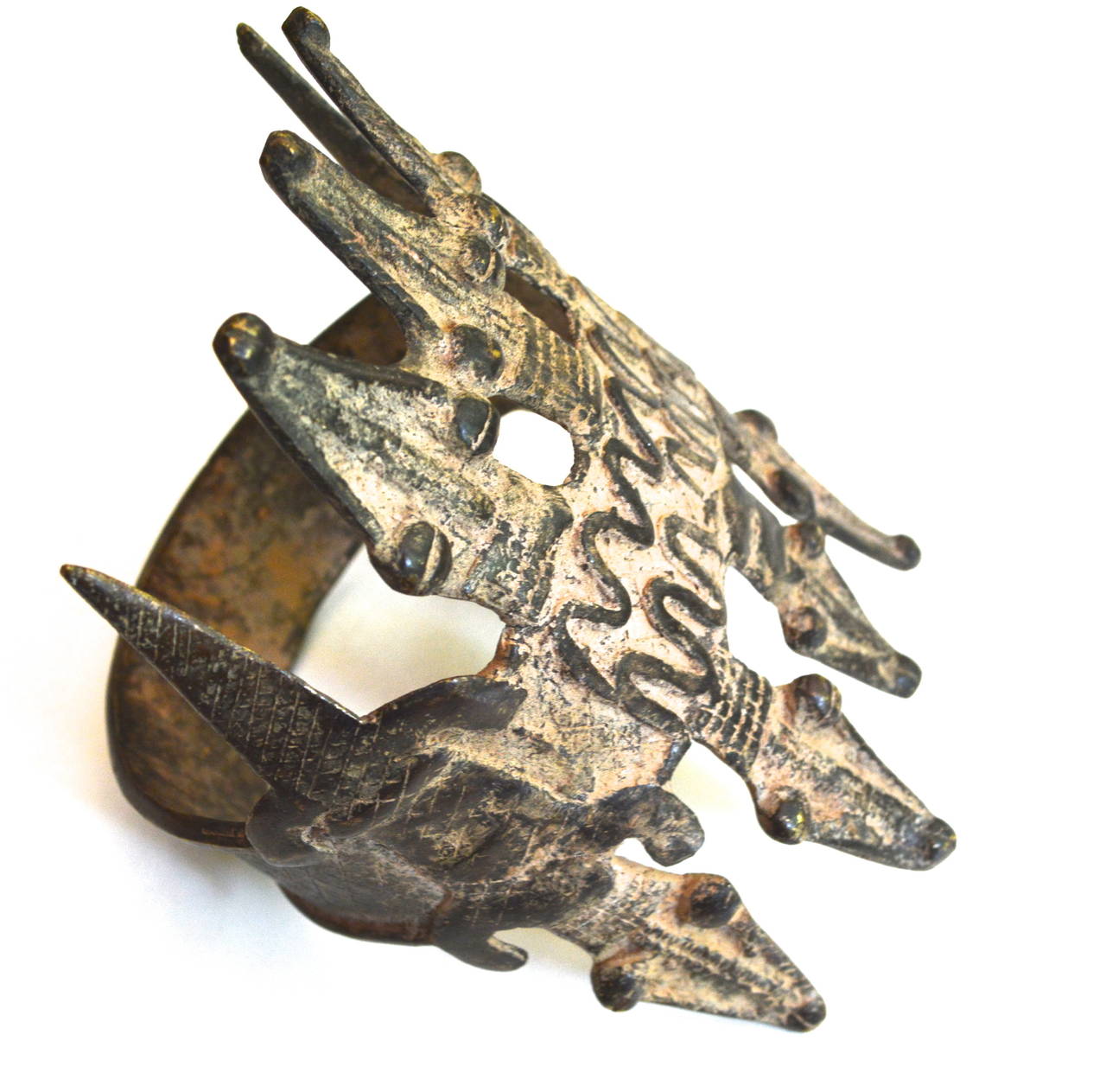 Old Lobi of Burkina Faso large crocodile bronze armband with a great patina and exceptional design. About 11oz. The crocodile is regarded as a protector or more sacred spirit. The crocodile iconography is believed to help ward off evil and is