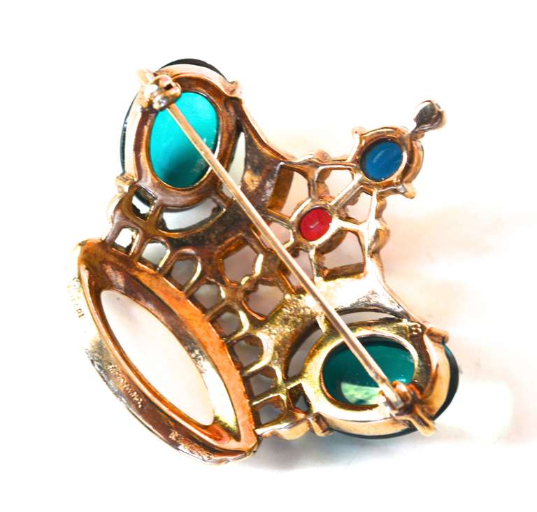 Highly collectible large crown pin designed by Alfred Philippe for Trifari in the 1940s. Vermeil over sterling with two large green cabochons and a smaller red cabochon with blue, red and clear rhinestones.  Part of the fall/winter pin