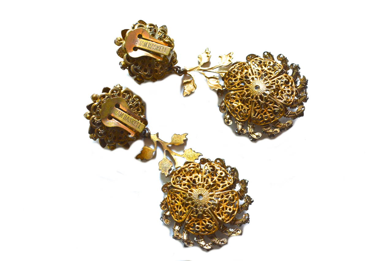 Signed Miriam Haskell floral drop earrings with crystal rhinestone accents. Classic construction and iconic design elements. Clip on style. 2.75