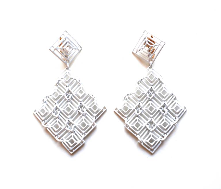 1960s white enamel geometric cuff and earrings set, signed Trifari. The drop earrings have a great scale. Earrings measure 3.5