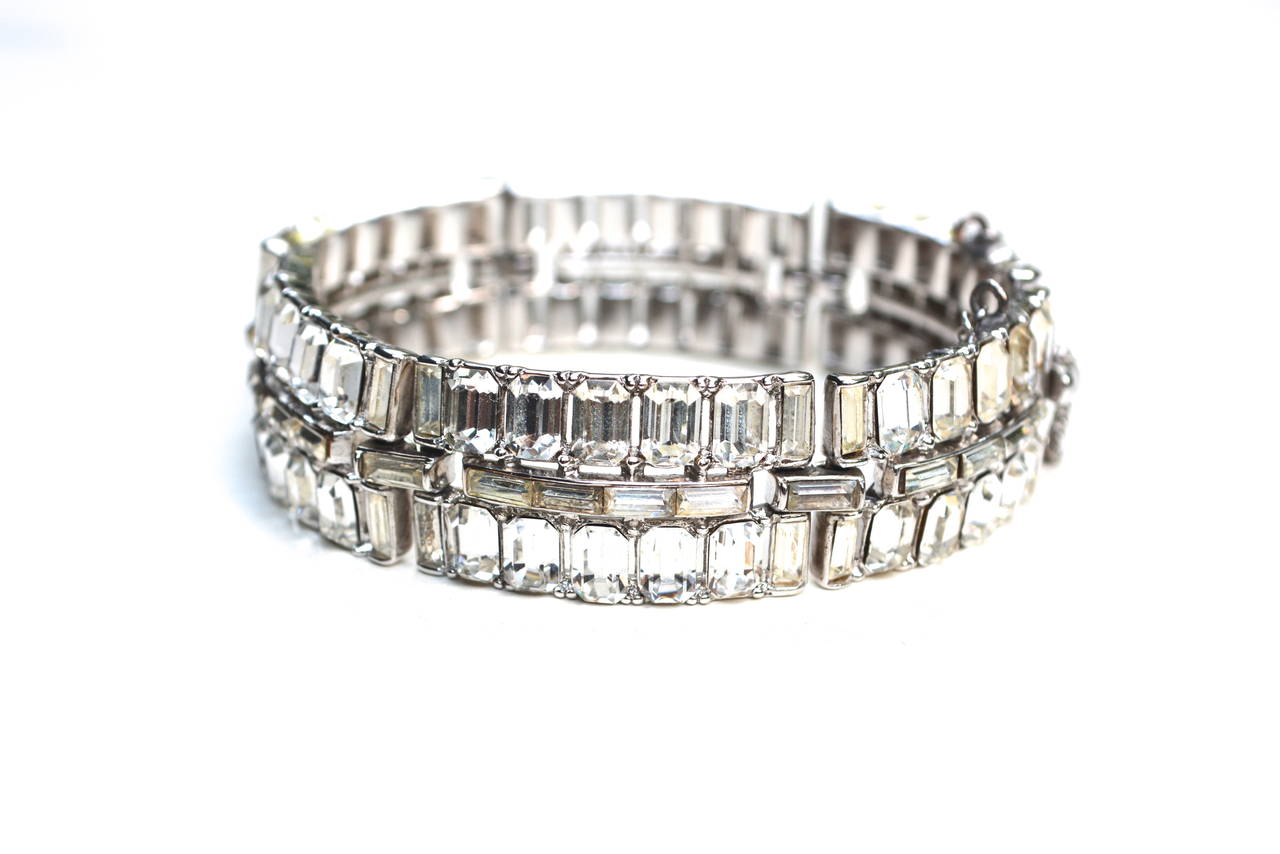 Glamorous signed Trifari cut glass stone bracelet with a security clasp. The piece has a bright lively wearable design.