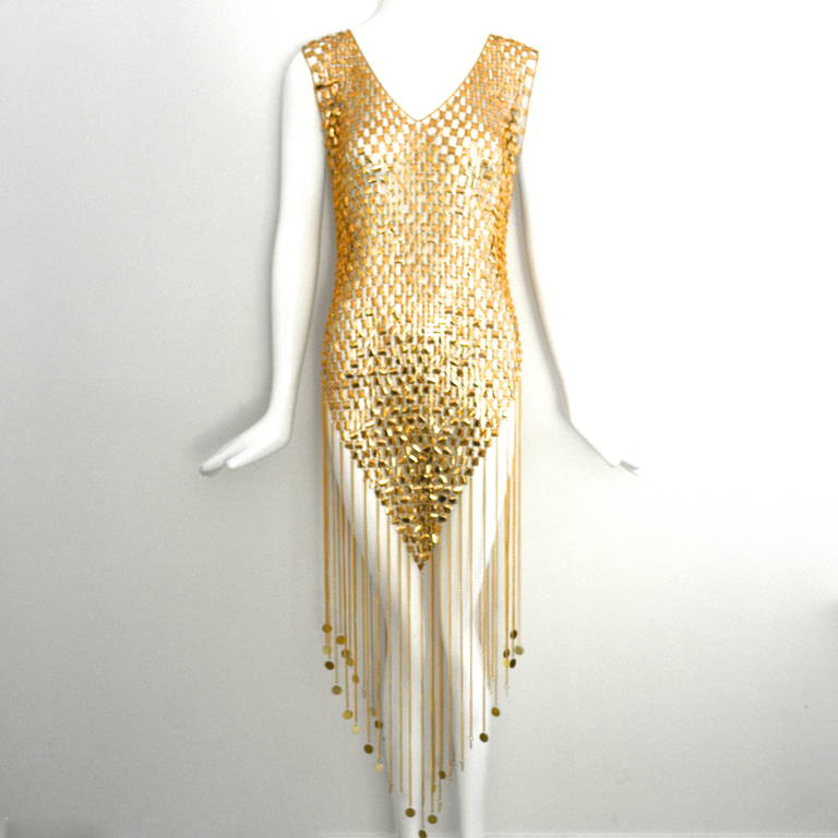 Vintage circa late 60s-early 70s Paco Rabanne golden link dress. These have been documented at auction and in collections. Recognizable by the light green color of the inside of each disc.  These were not tagged or signed. This sort of flapper