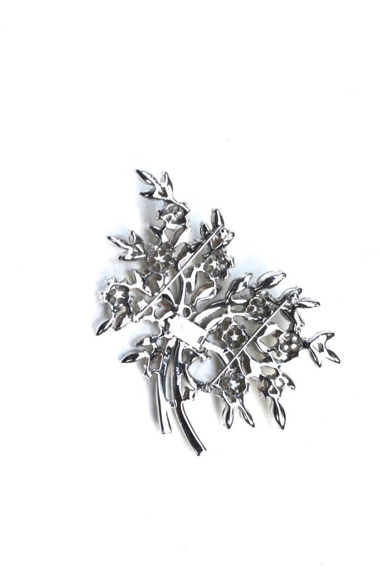 Large convertible floral bouquet brooch by Trifari, signed. Converts by lifting the middle square clasp, opening it, separating the two, sliding the clasp to one side and closing it. Stunning impact as two pieces or one. Old hollywood style.