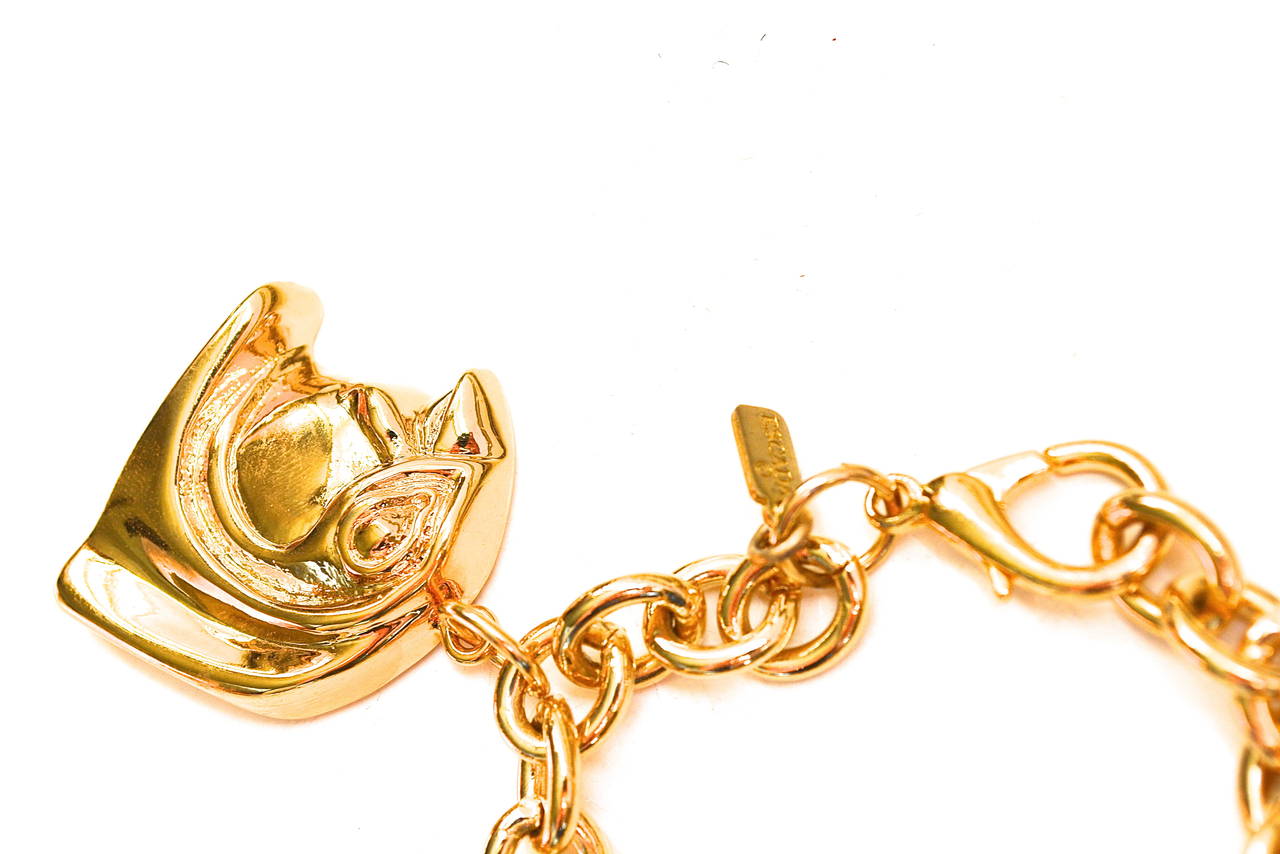 Chunky golden metal signed Escada Egyptian revival charm bracelet featuring the head of Horus. Charms are about 1.25