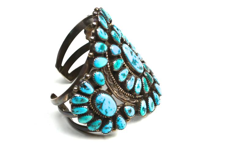 Fantastic signed 1960s-70s North American turquoise and Navajo silver cuff.  The colors found in these stones are truly stunning and rich. It has a great scale, as well on the wrist. Signed JWM sterling.  The Navajo artist Jessie Williams did work