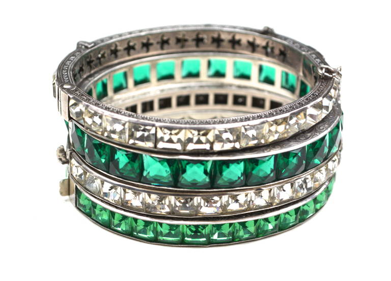 Stunning and rare larger collection of 9 sterling and faceted channel set glass 1920s bangles. The set includes the rarer green shades and larger bangles. In fact the collection has 5 of the medium to larger sized bracelets and four smaller ones.