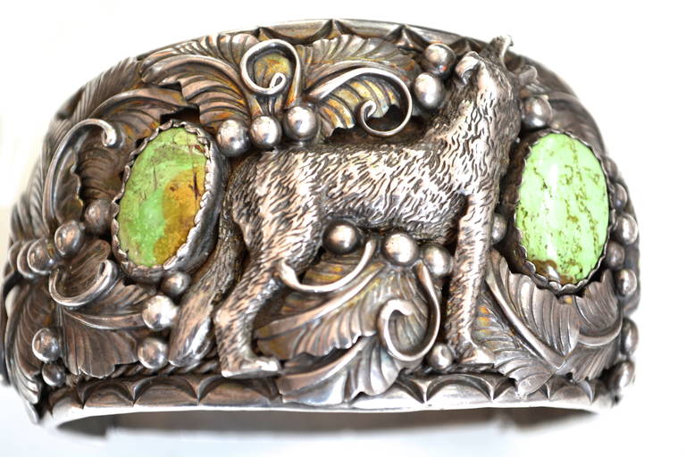 Vintage signed N sterling Navajo wolf cuff featuring a lovely green turquoise with matrix. The wolf even has visible teeth. I have seen similar motifs before in Navajo works, but not with the green turquoise. The piece was made for a man, but later