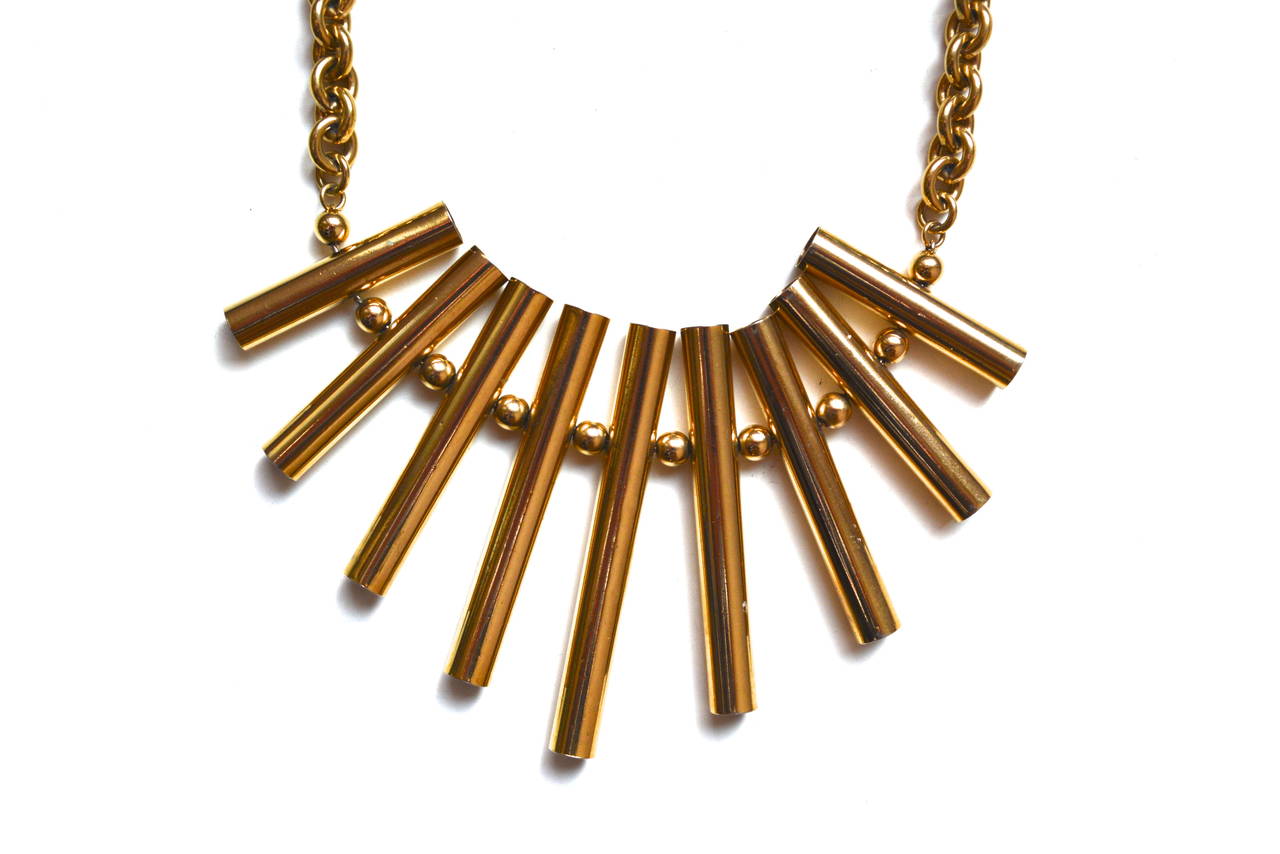 Pierre Cardin golden geometric tube fringe necklace. Signed with the P logo on the clasp. The chain has a great weight and feel. It has a versatile design and quality construction.  Width varies. The necklace has a good wearable length.  The longest