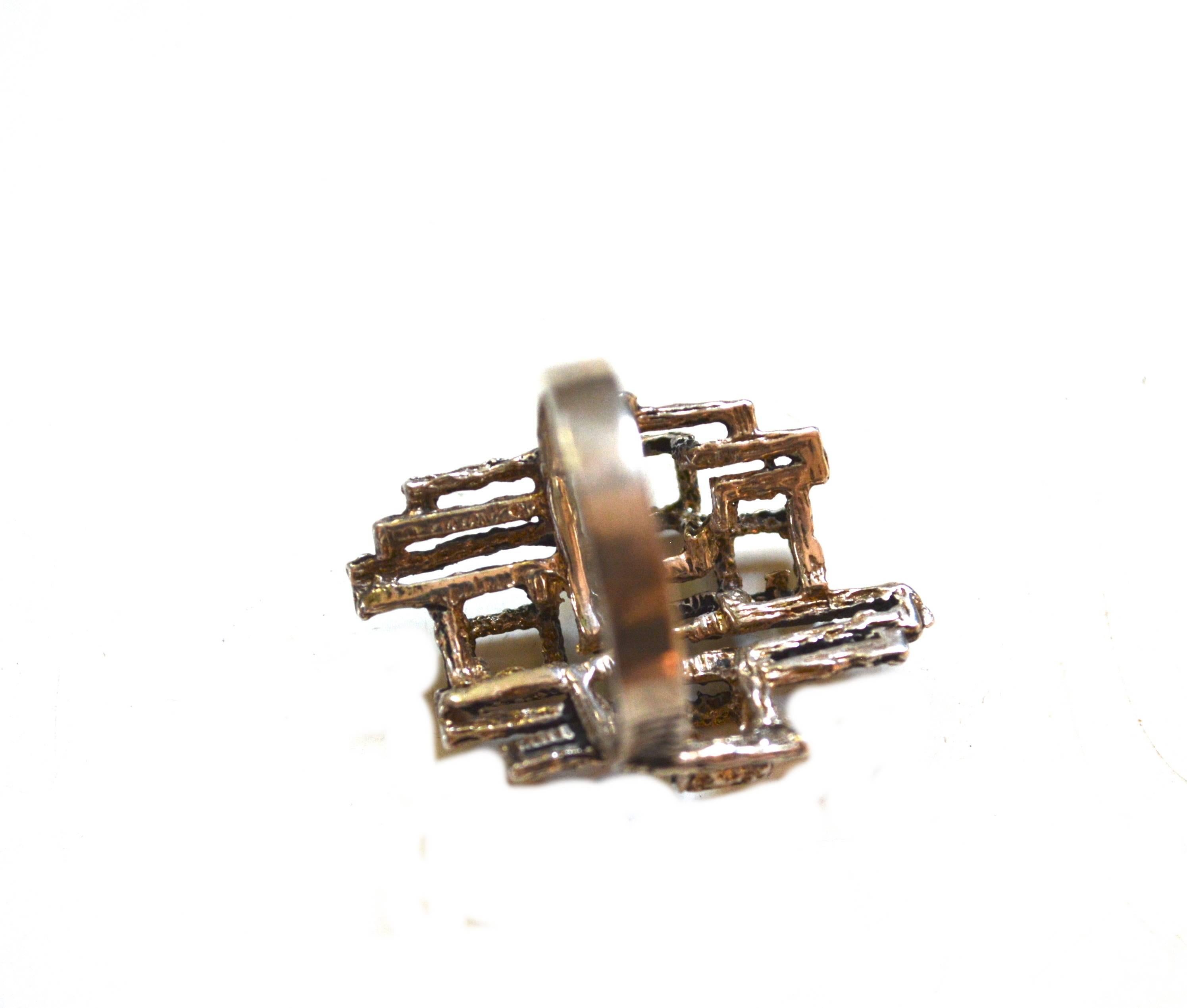 Marked sterling 1960s Brutalist ring with mod cube designs on a textured surface.  Size 6 3/4. The face measures about 1.15