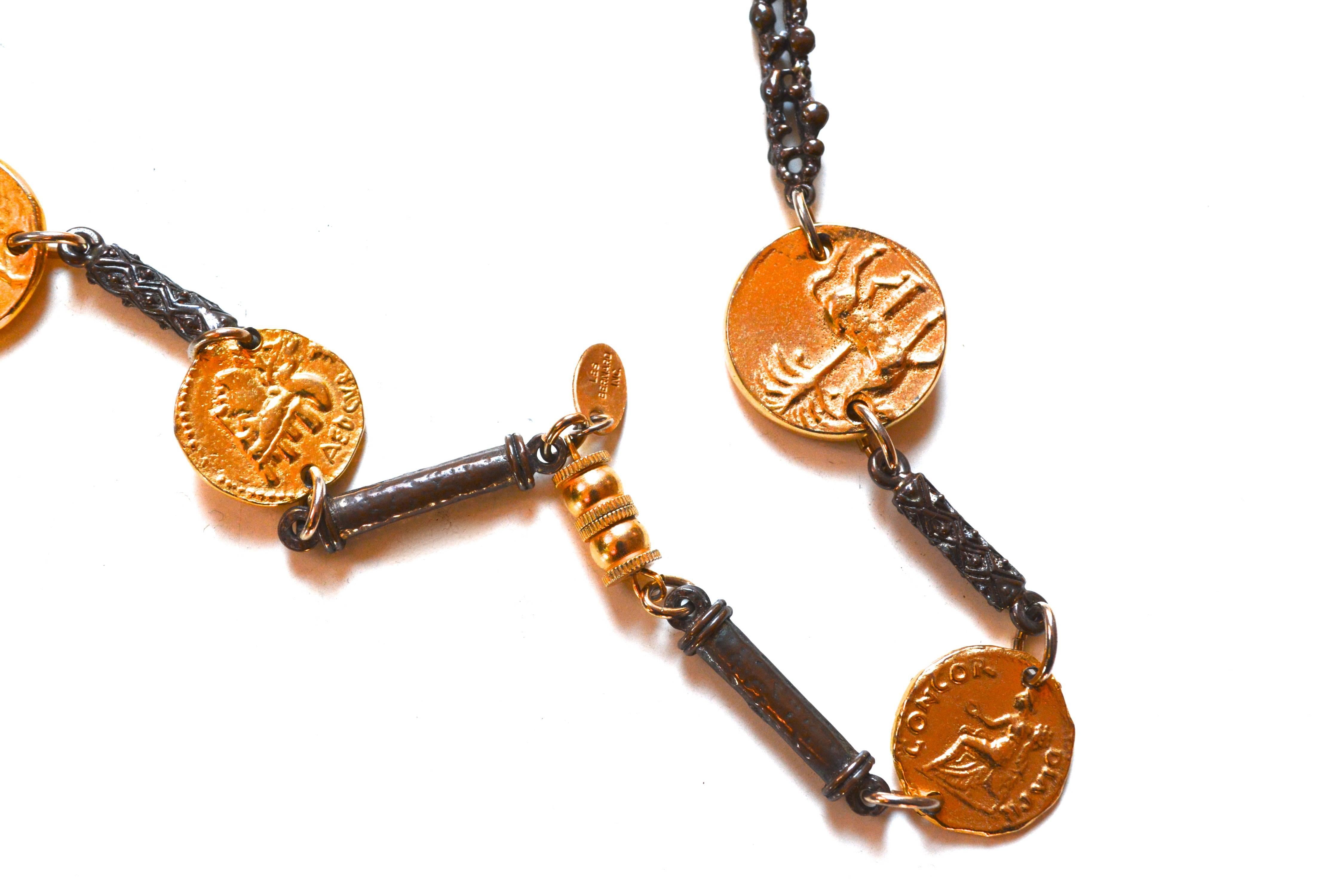 Signed Les Bernard gilt ancient coin style and aged metal knot link necklace. Unique detailed construction. The piece features various coin styles based on authentic historic artifacts. Largest center coin is 1