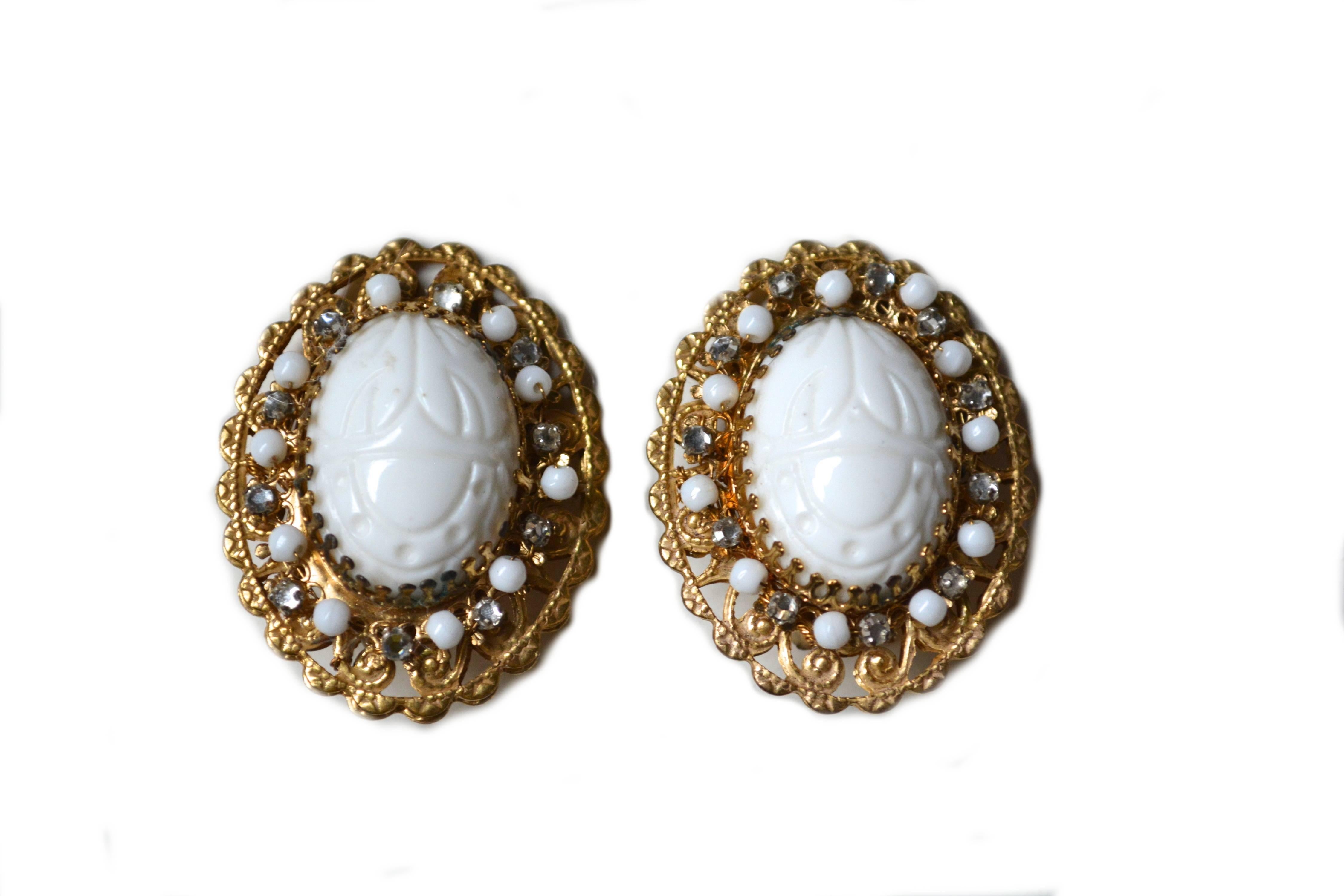 Milk glass scarab clip on earrings, signed Stanley Hagler.  Lovely white scarabs and Egyptian revival theme. Wired in beads covered by final filigree back.  2