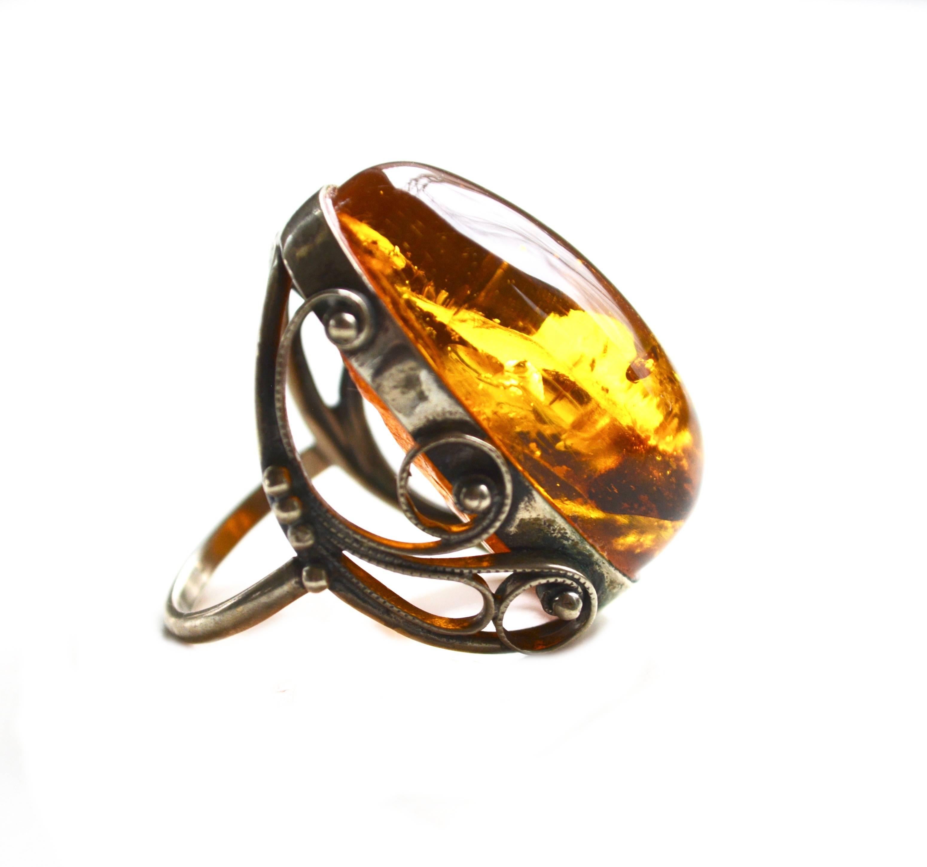 Oversized beautiful amber and sterling ring brought back from Latvia in the 1970s.  1.5" long. Size 7.5.