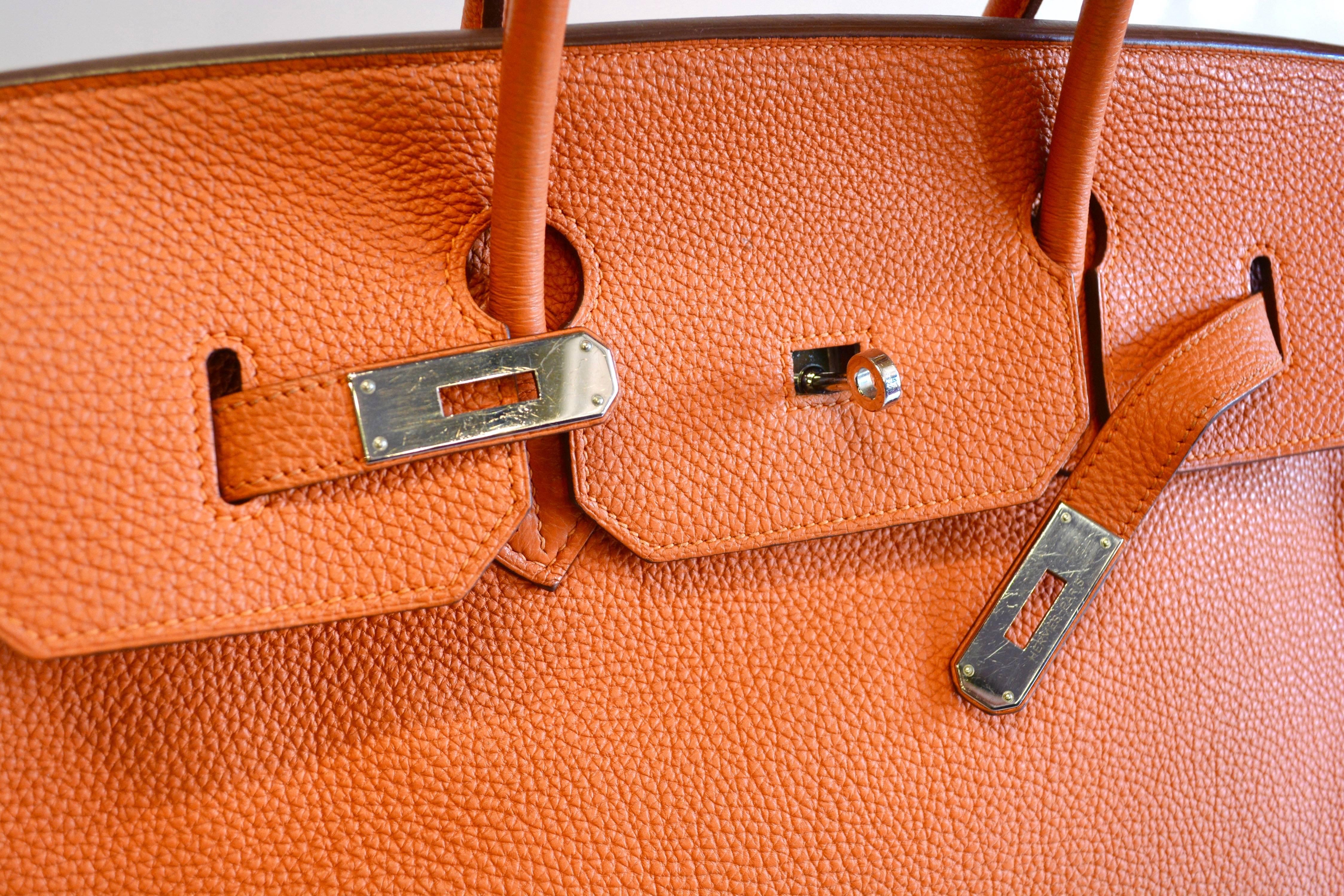 40 cm classic Birkin bag by Hermes in a lovely orange togo leather.  Condition is very clean with minimal wear as seen on the handle, which may need cleaned. Inside is clean and the body very good.  Includes the original box and lock.  Silver