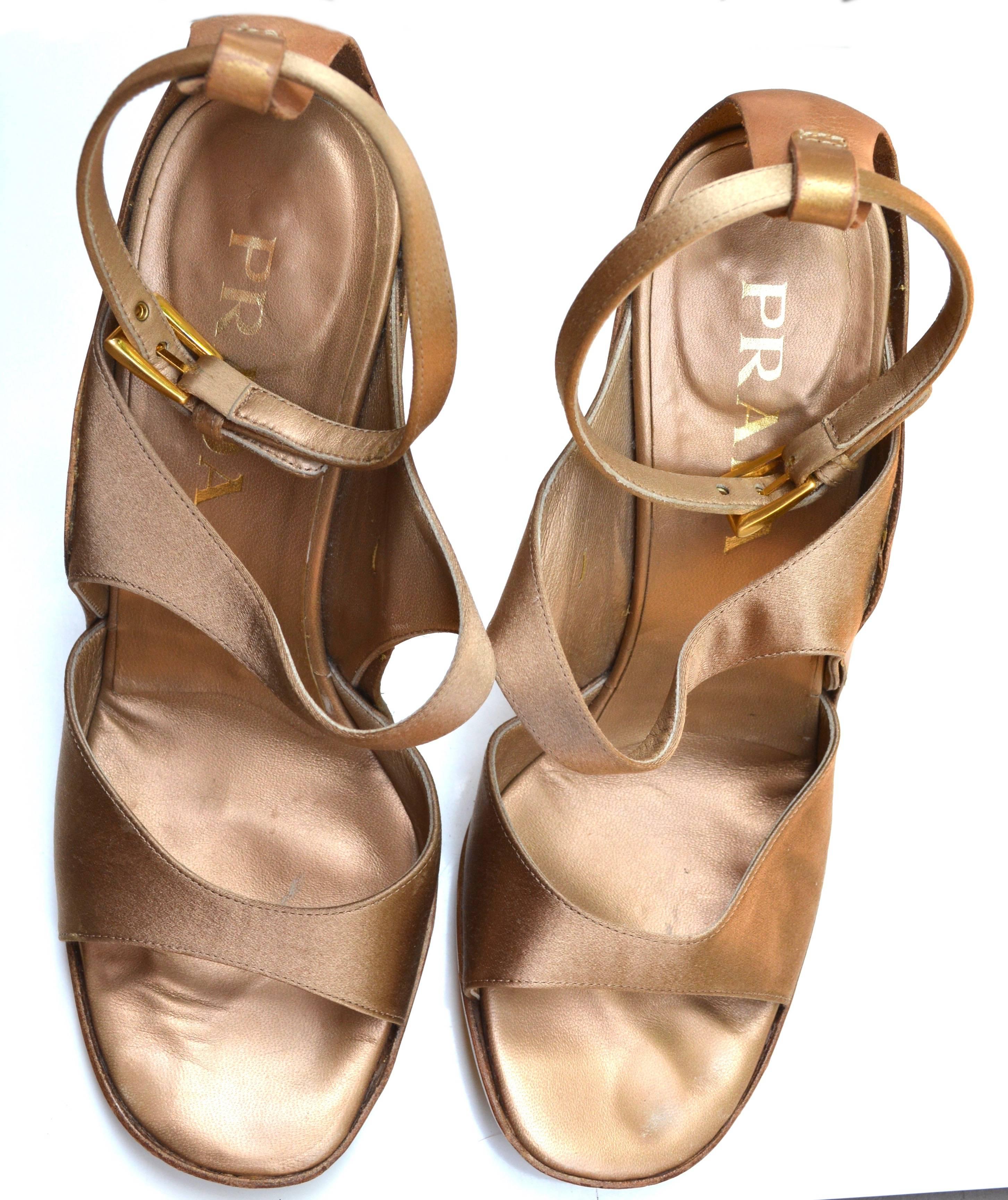 Circa late 90s early 2000s bronze satin sandals by Prada. Size marked 38 1/2. Condition is good with no major wear, subtle signs.  The straps are strong and they retain the shape when on the foot.  Satin is in good condition. When on the foot