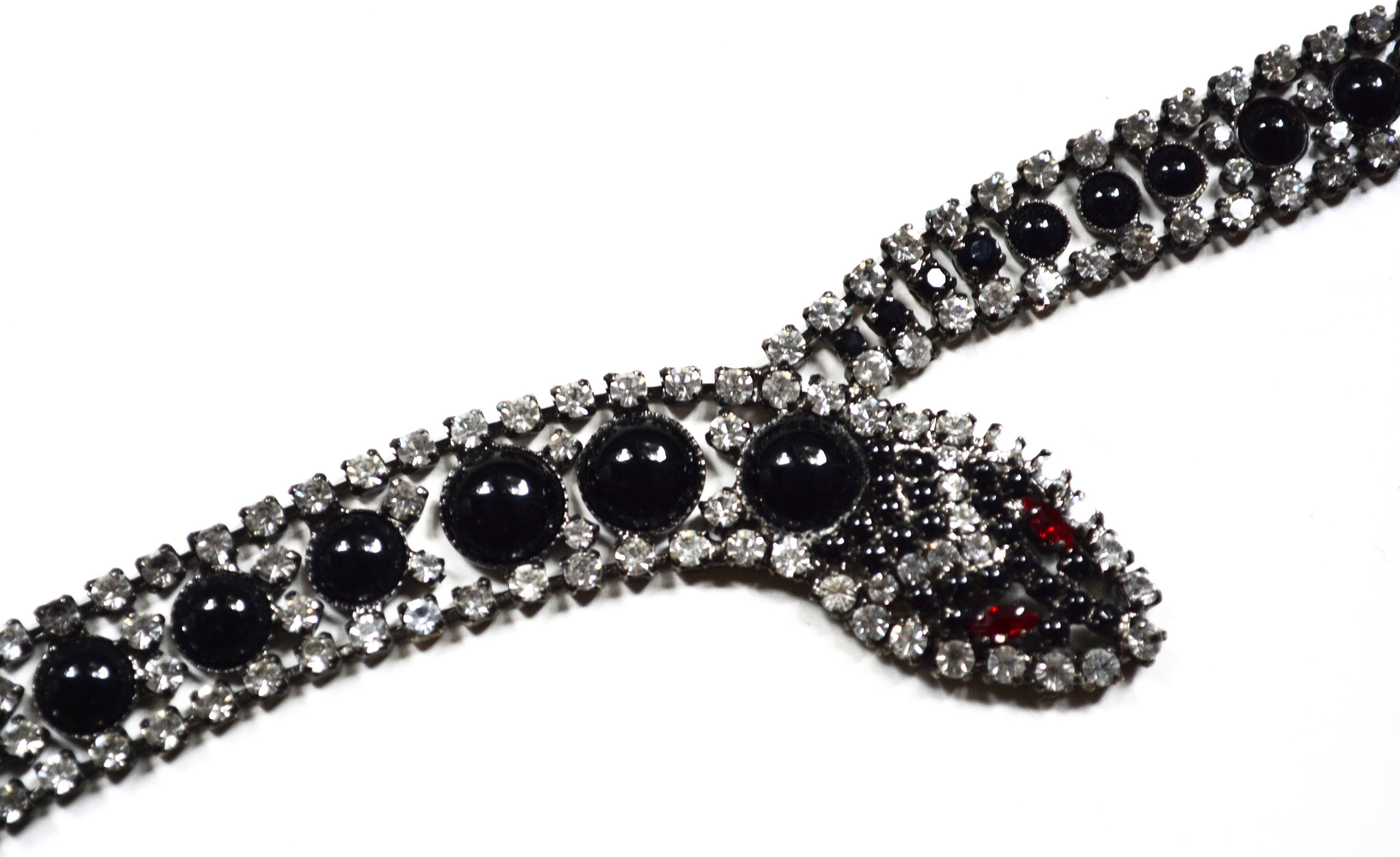 Rhinestone signed Butler and Wilson snake bracelet with black accents. They also created a necklace in this style. Red eye details. Length is 7