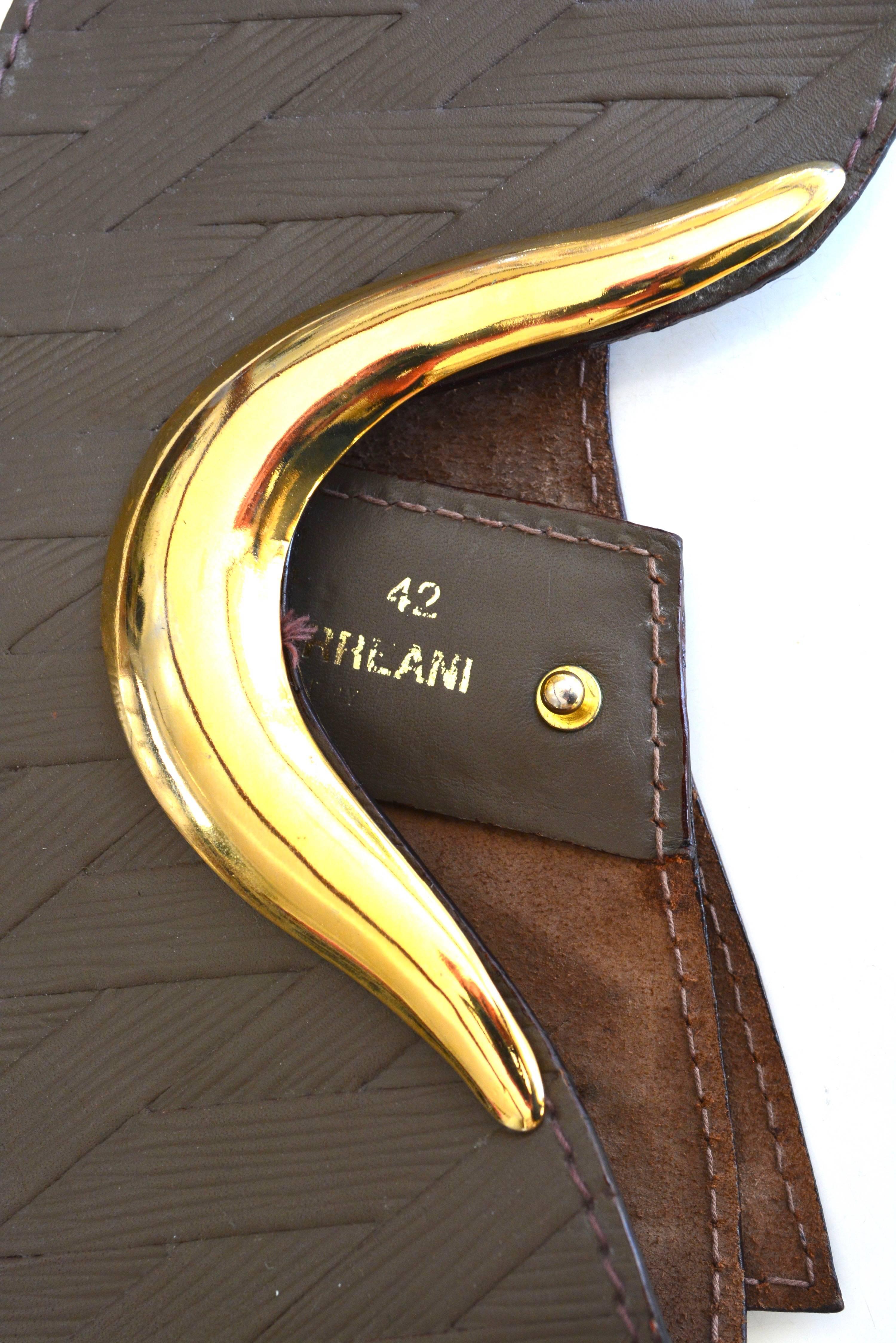 Circa late 70s-80s Ugo Correani signed made in Italy leather embossed belt. Marked a size 42. 32" long x 5" wide. It is adjustable.  Condition is very good with mild wear to the gold detail. 
