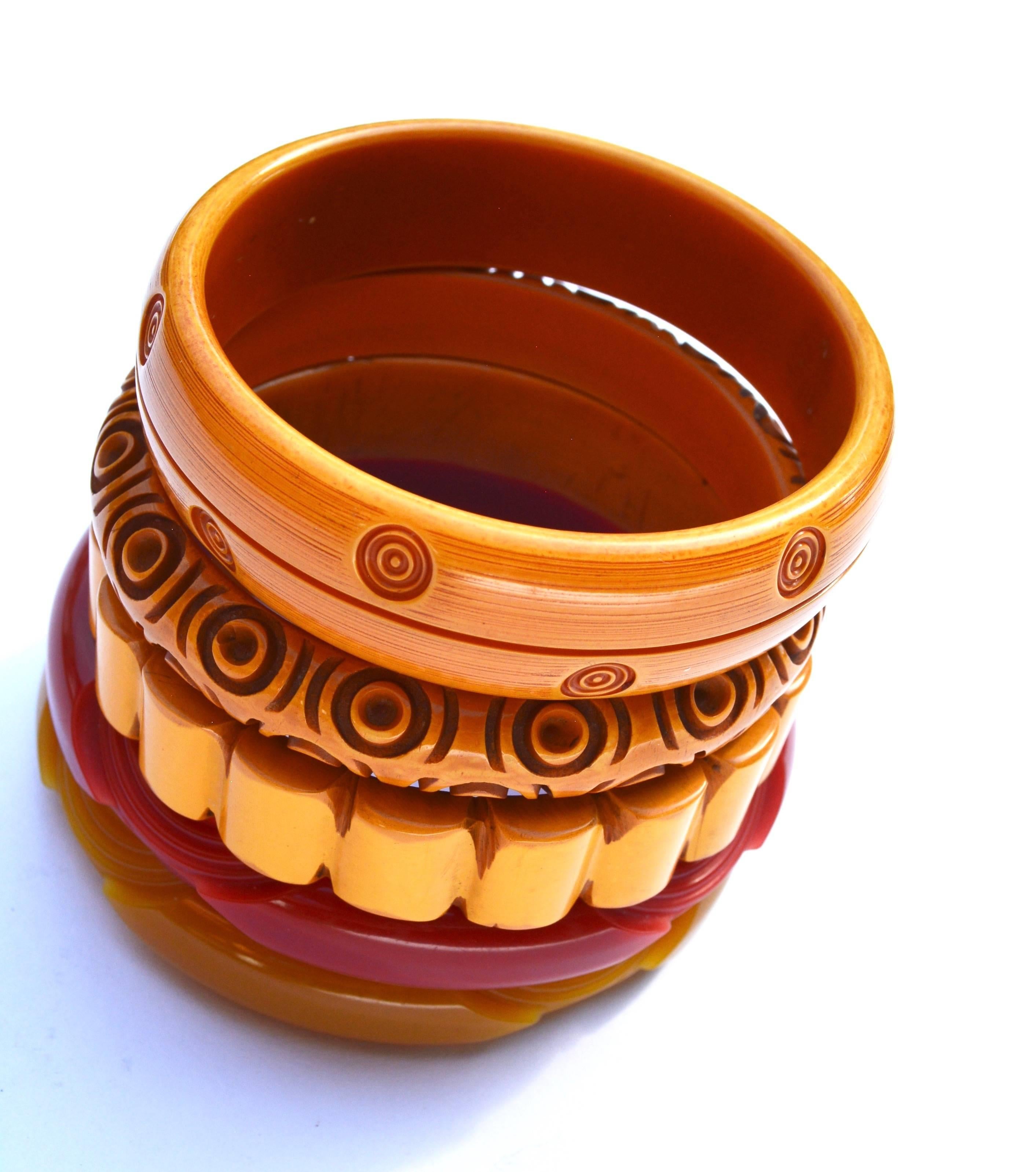 Set of 5 red and amber yellow Bakelite carved bracelets. Circa 1930s-40s. Ranging from about .75" wide to 1". 