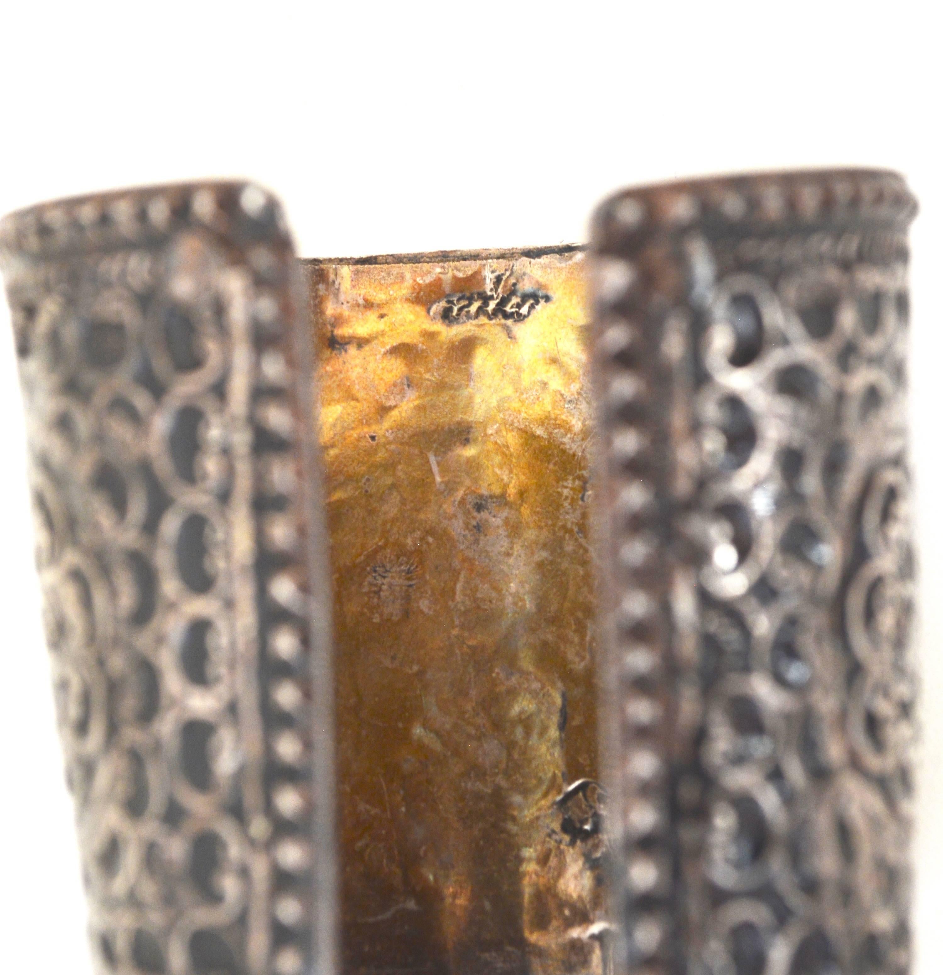 Pretty and intricately styled Berber cuff with some age. Appears to have enamel or black between the cut silver designs. Tested sterling according to the jeweler. It features studded detailing.  First opening is about 6.5" with flexibility and