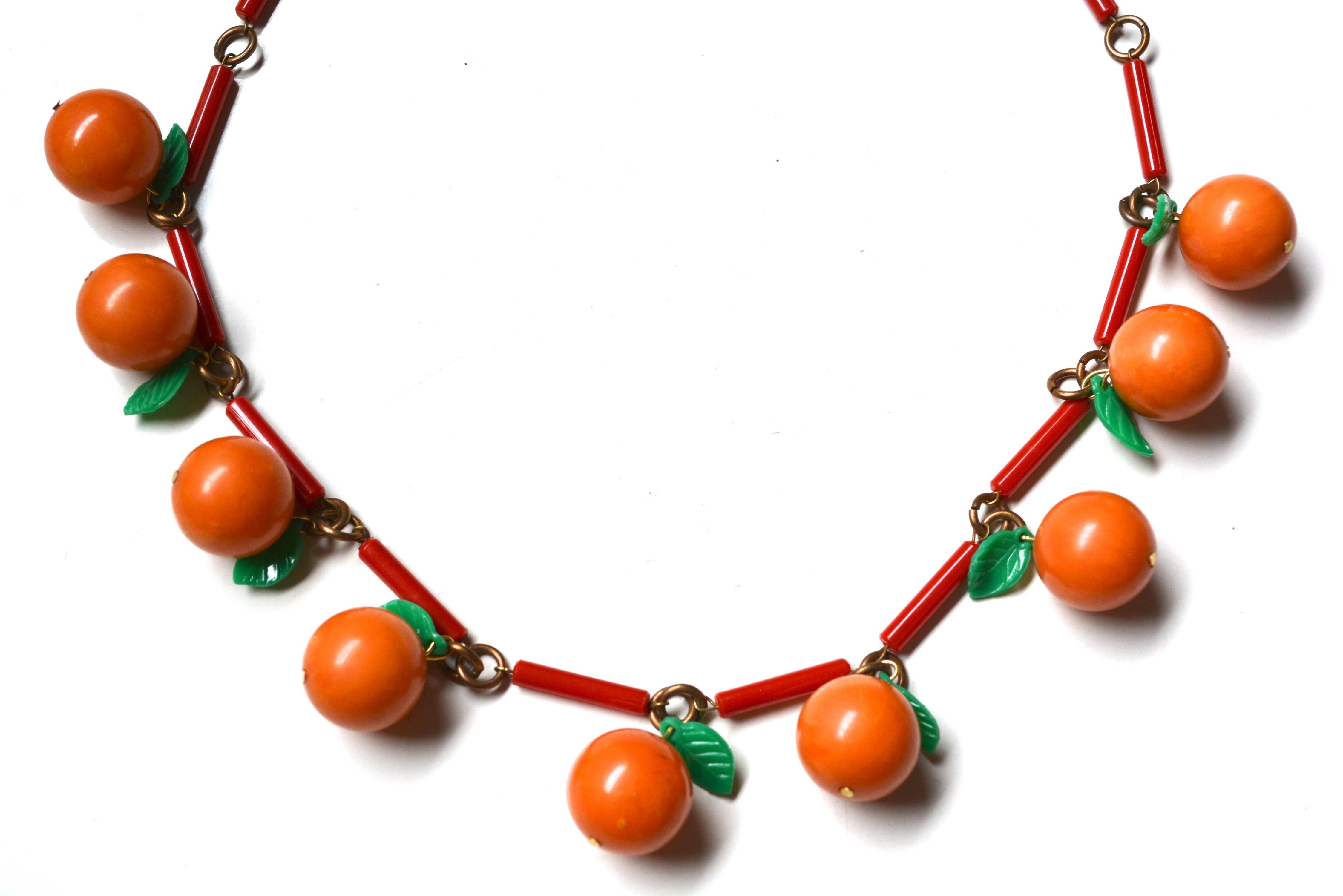 Hard to find bakelite and celluloid oranges or orange cherries necklace. Unsigned. Oranges are a great swirl tone and tested bakelite. Each orange is round and about .80