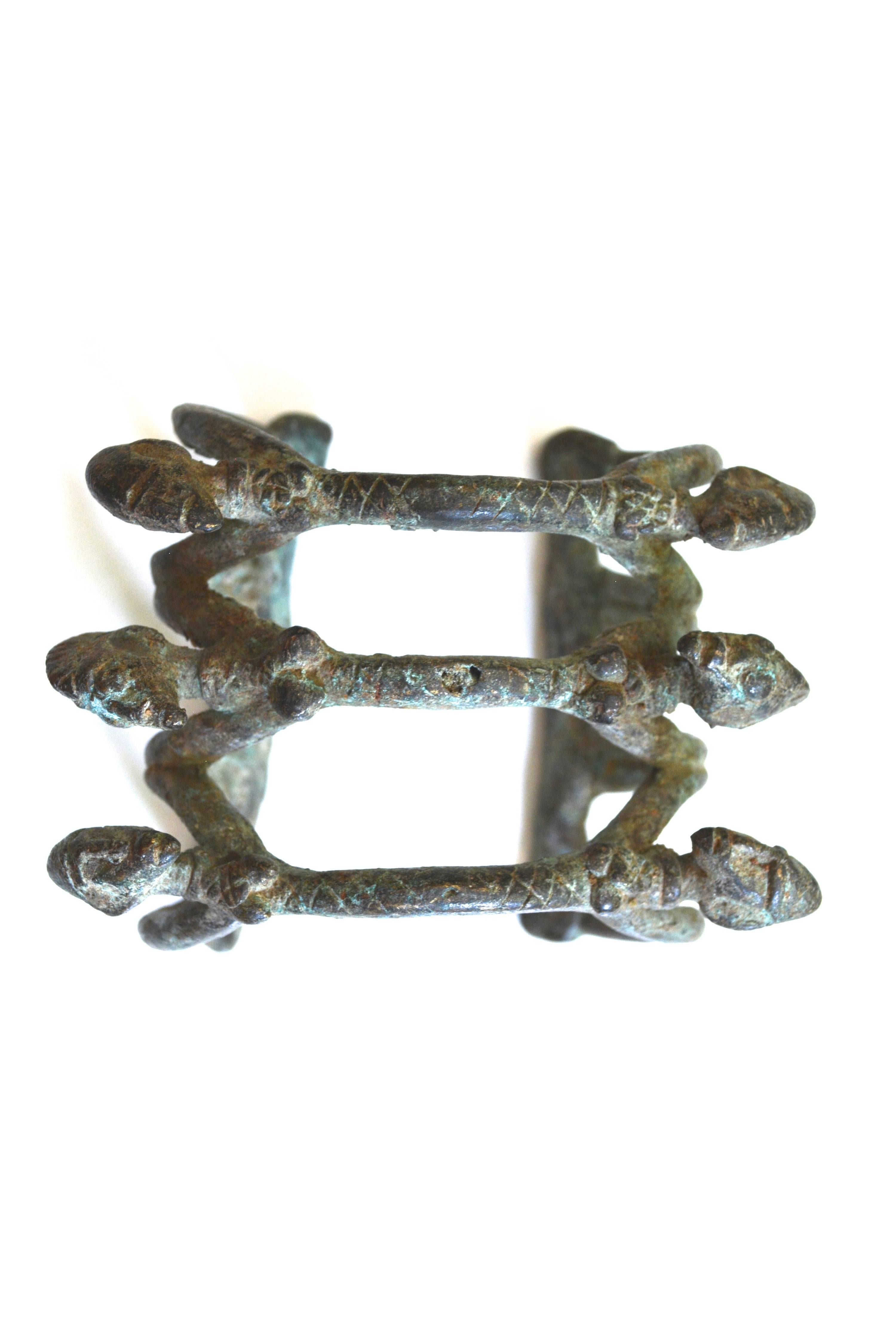 Antique circa early 1800s bronze fetish figural bracelet made by the Dogon of Mali from western Africa. These figures could be related to the nommo beings and water. Such bronze jewelry reflected status and were used as currency. 6 3/4