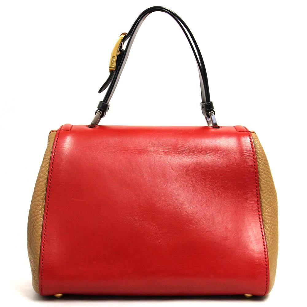Red and caramel leather Fendi "Silvana" tote bag featuring a black leather top handle, a logo twist-lock closure and one zippered pocket. Fully lined. 
Measurements: 21 cm x 27 cm x 15 cm
This piece is in very good conditions: some very
