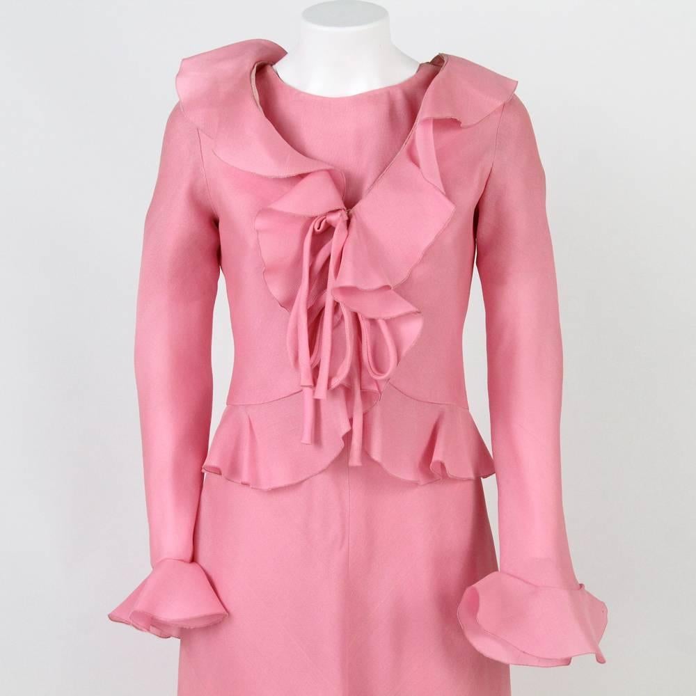 Lovely pink day dress suit designed by Stop Senes in the 1970s. This polyester suit features a long dress with delicate frills on the hems of the skirt and of the short sleeves, plus a cute chic frilly jacket.
Very good