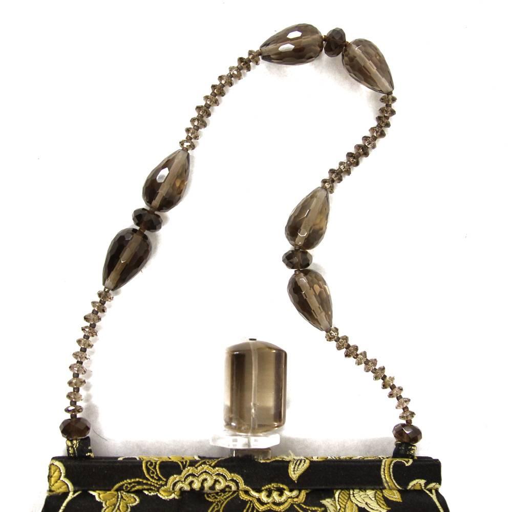 Glamorous Dotti purse in jacquard silk with golden embroidery. Lovely precious handle with beads. Perfect to carry all your essentials in one hand. Good conditions.

Measurements:
18 cm x 16 cm x 4 cm
Handle width: 15 cm

