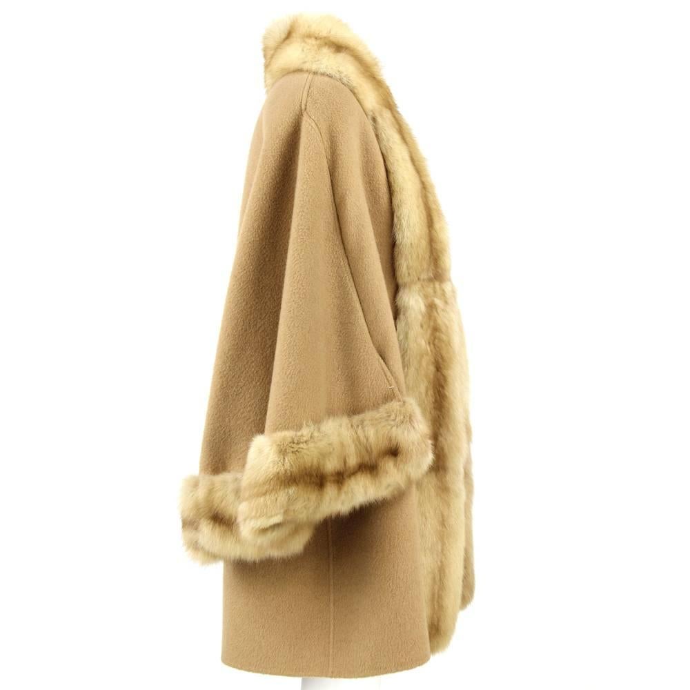 Valentino flared camel coat le fur and lined with mink. It features wide sleeves. Open on the front, no buttons. 
Height: 86 cm 
Bust: 52 cm 
Shoulders: 46 cm 
Sleeve: 59 cm