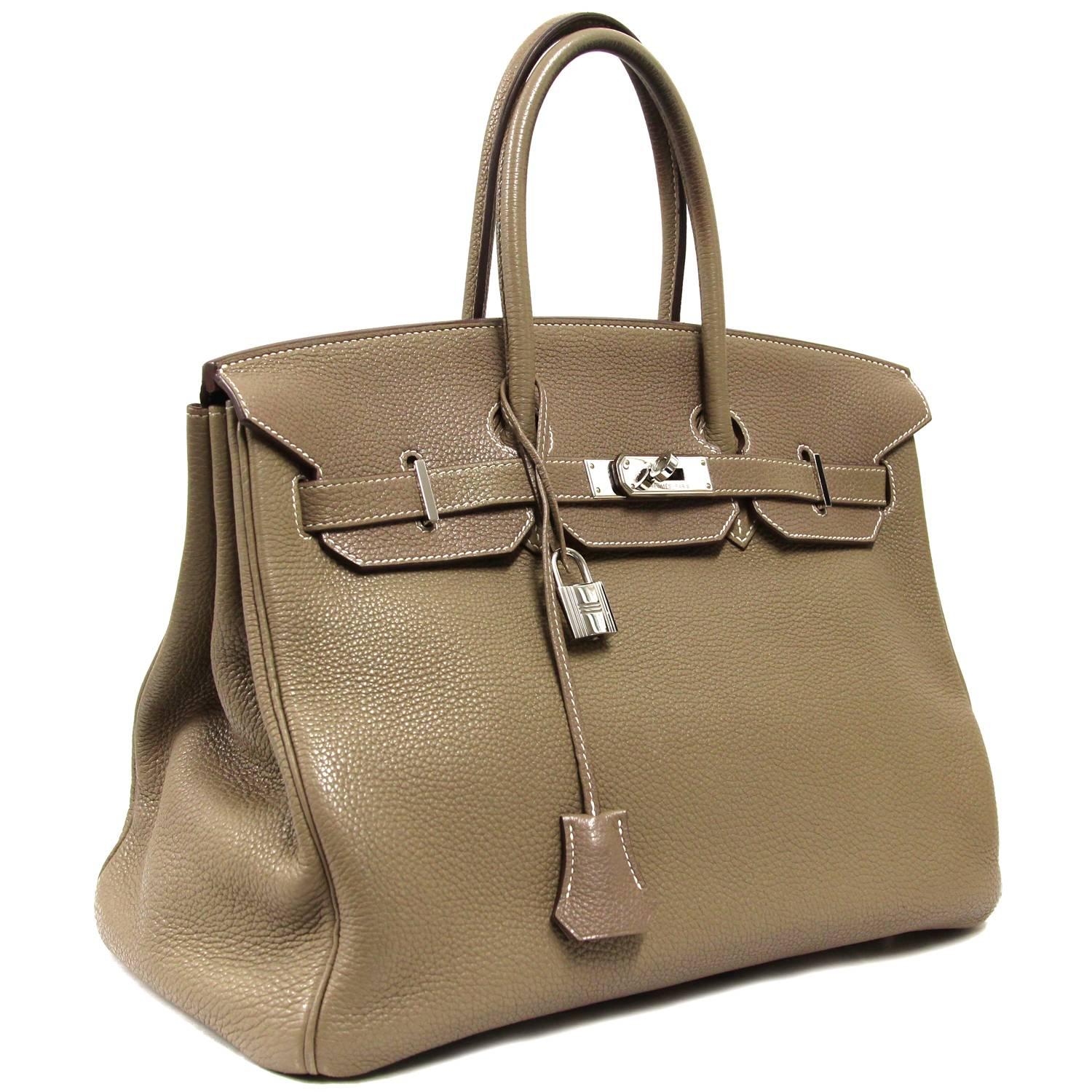 Fabulous Hermès Birkin bag 35 cm in taurillon clemence Leather "étoupe" color. According to the embossed code the item was produced in 2009, code: [M]. The item comes with padlock, keys and clochette and dustbag. The metallic parts have